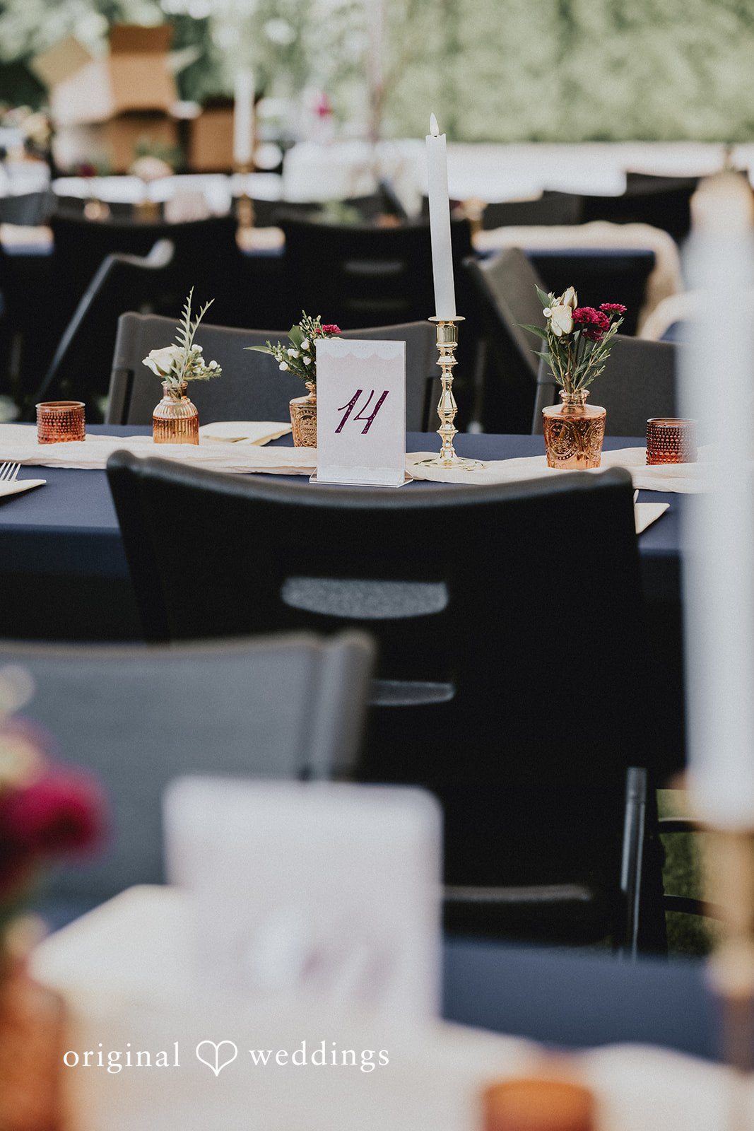 Catherine + Gabriel Close-up of minimalist table settings with small card numbers.