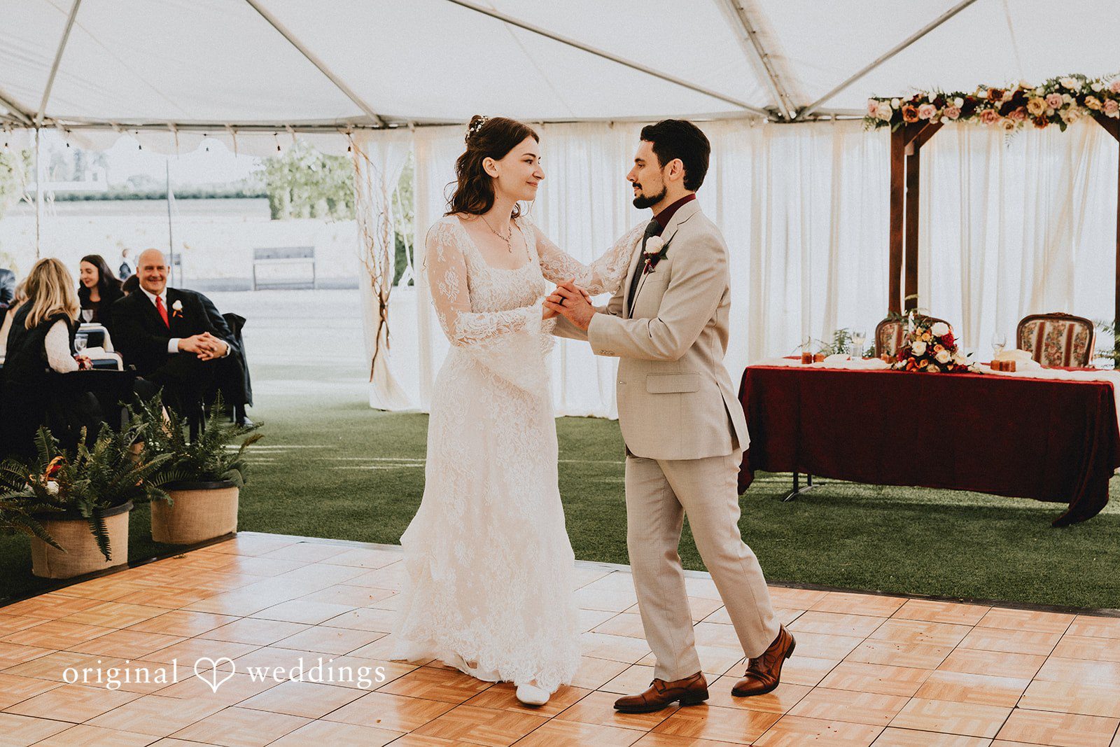 Catherine + Gabriel Bride and groom holding hands and dancing together.