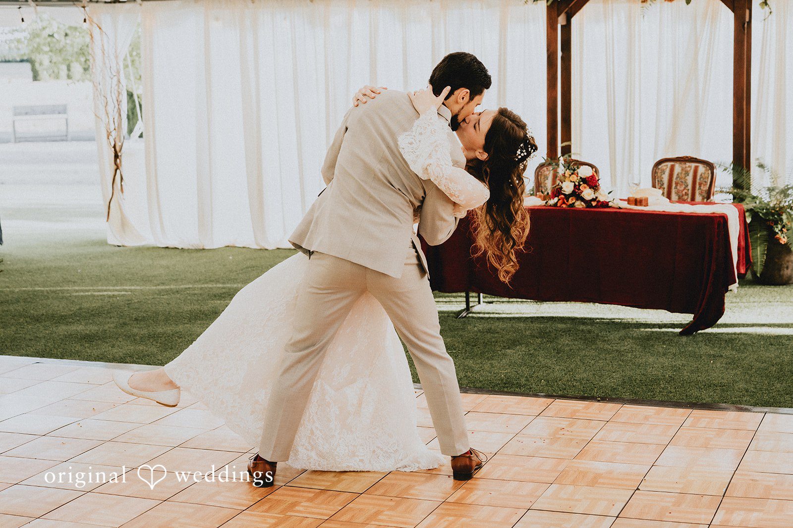 Catherine + Gabriel Groom dipping the bride while dancing on a tiled floor during the reception.
