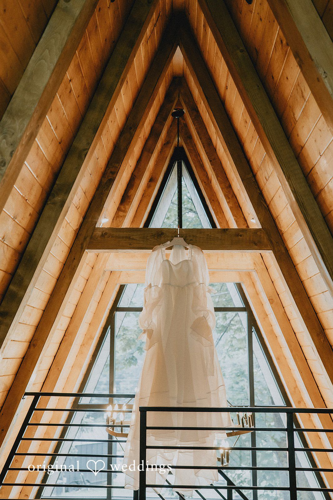 Ben + Erin Beautiful picture of white wedding gown hanged across the pillar at Paradise Inn