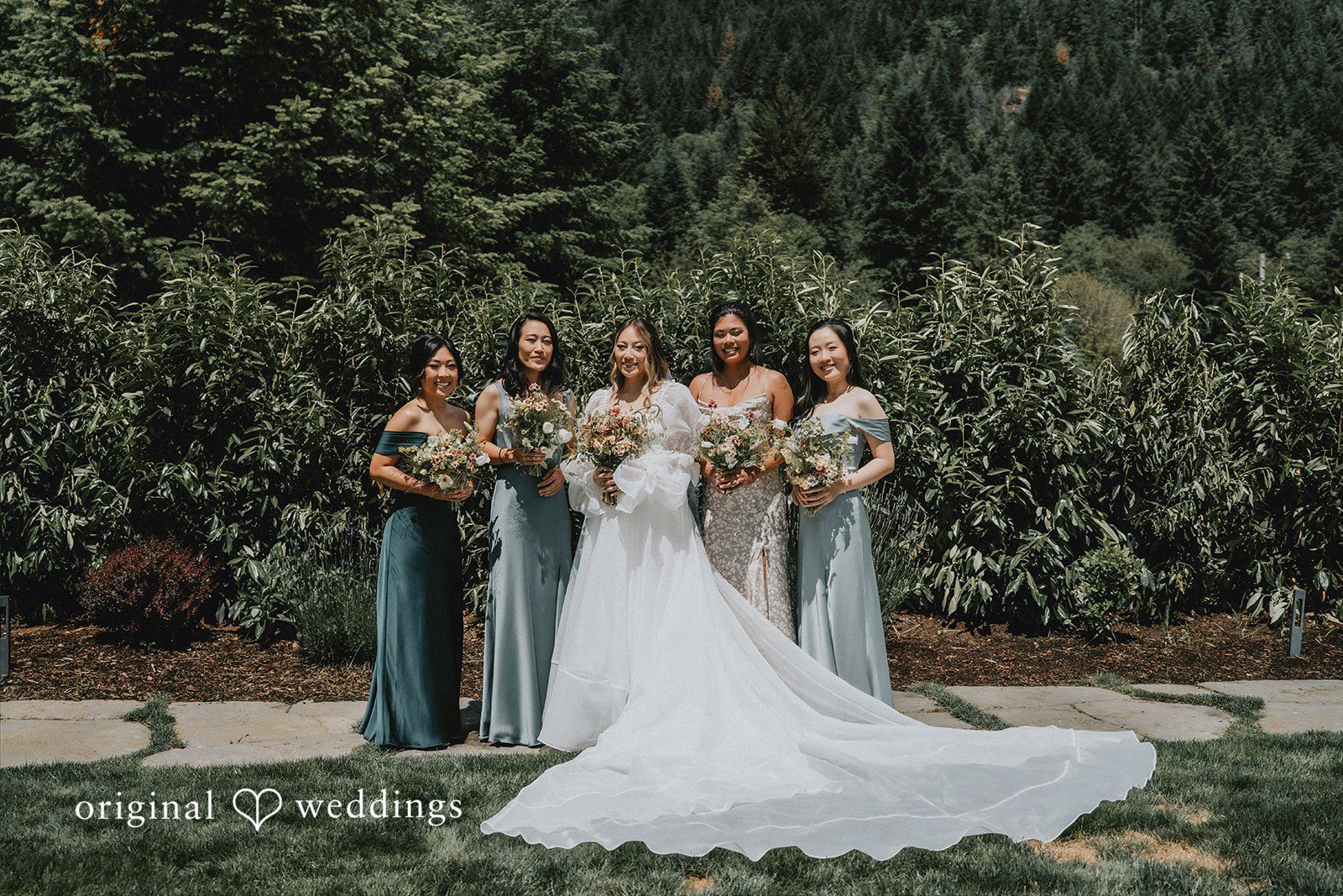 Ben + Erin Beautiful picture of bride with bridesmaids, all smiling and holding bouquet