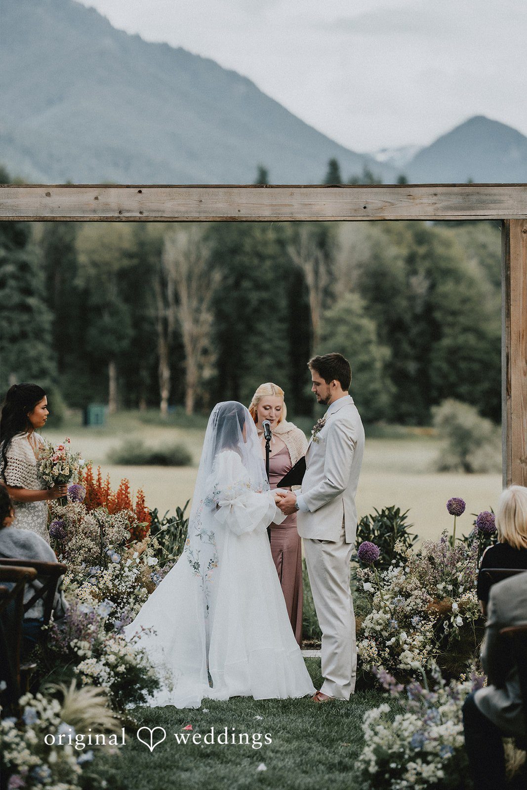 Ben + Erin Bride and groom exchanging vows during an outdoor wedding ceremony.