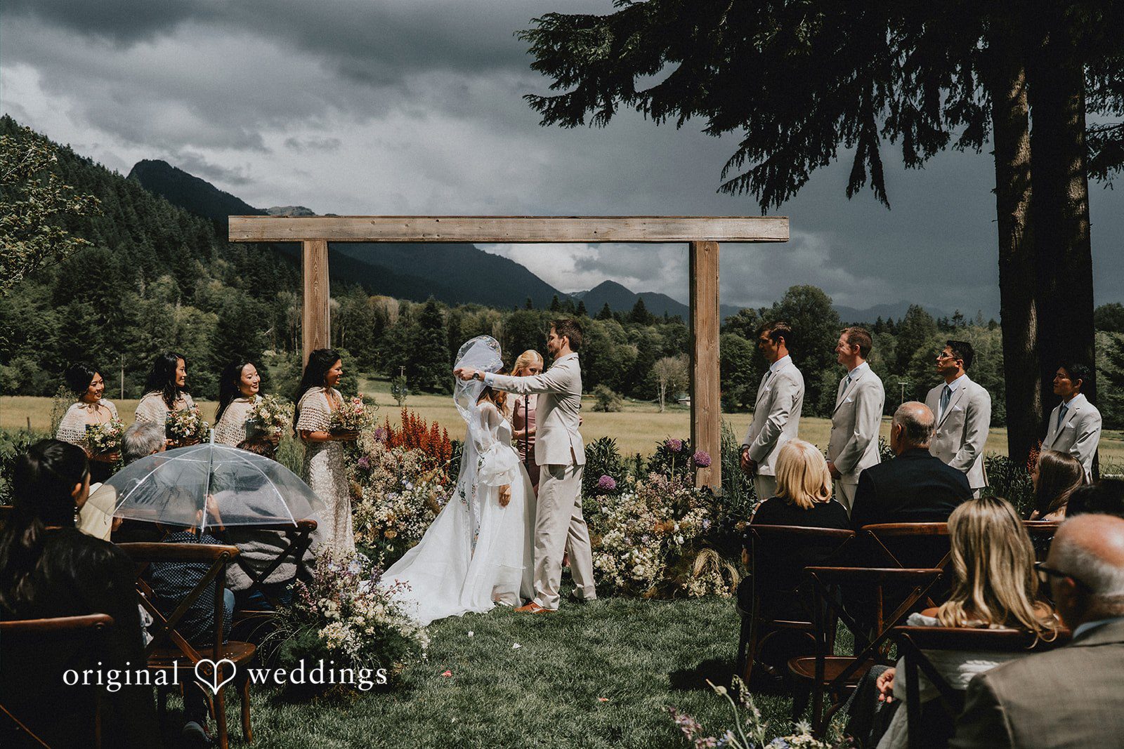 Ben + Erin Groom revealing the face of bride during an outdoor wedding ceremony