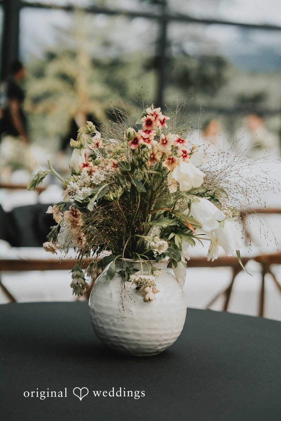 Ben + Erin Close up shot of a vase with flowers captured by team of Original Weddings