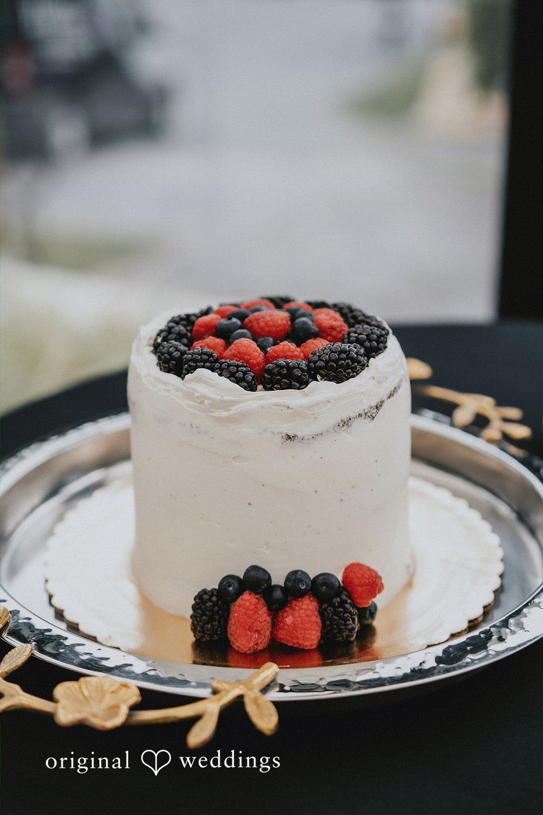 Ben + Erin Lovely shot of white wedding cake decorated with berries