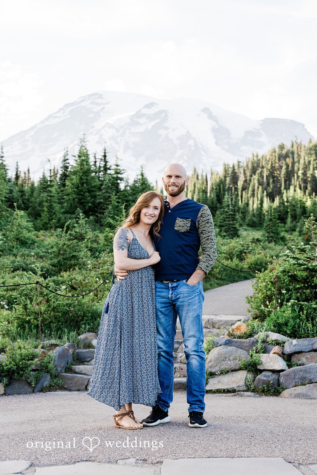 Megan + Kevin A man and a woman stand together on a gravel mountain path.