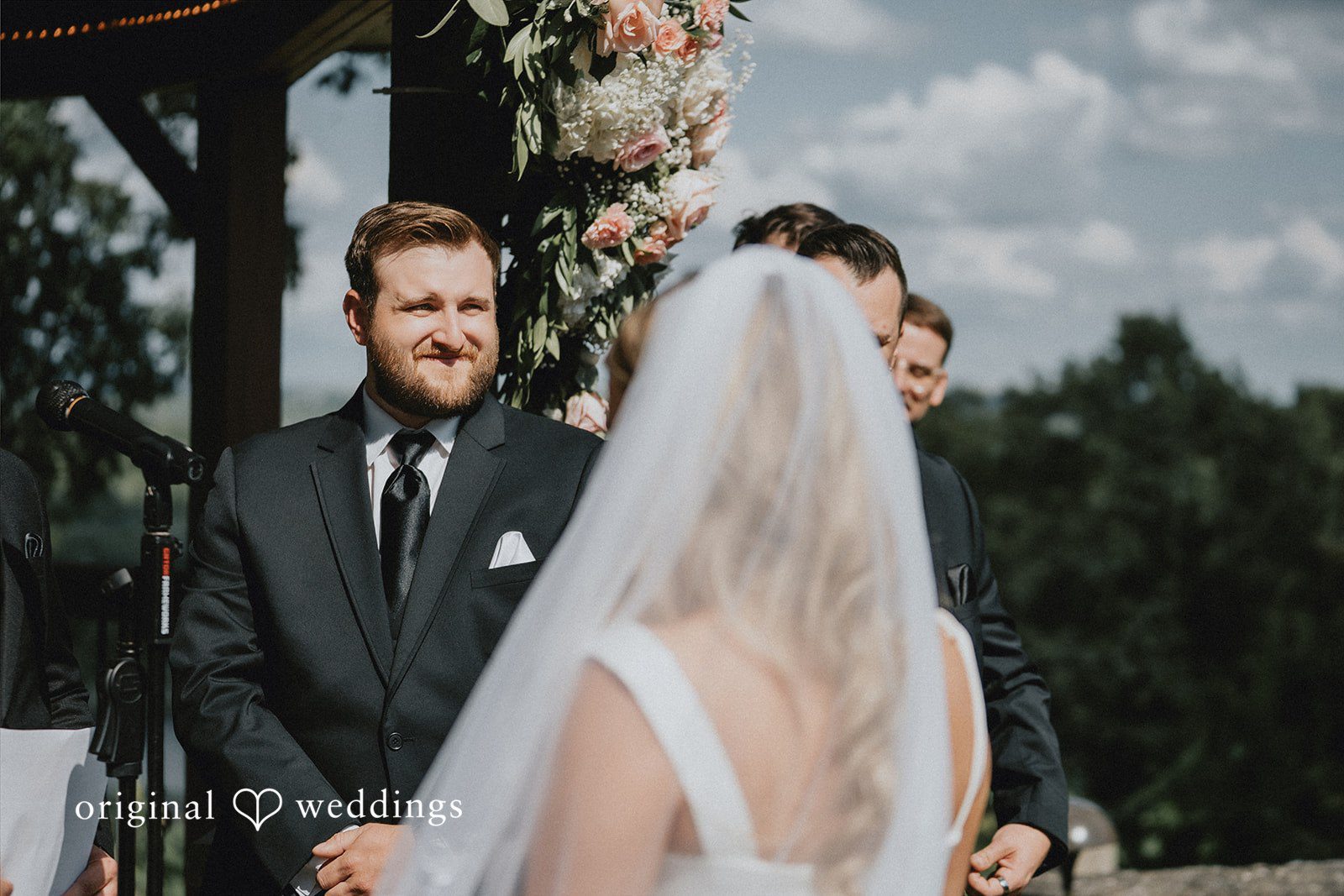 Close-up view of a wedding ceremony from behind the bride.