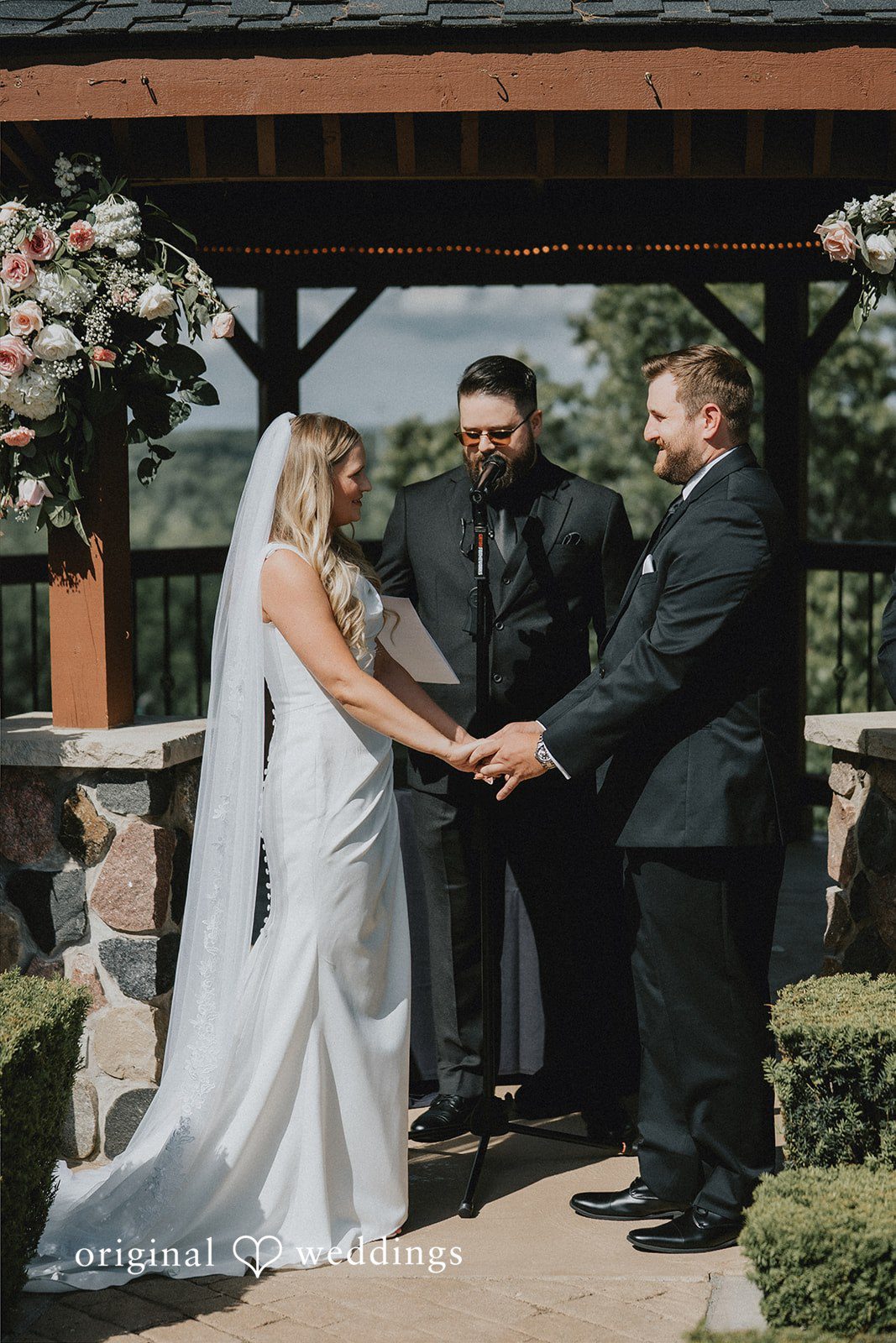 Bride and groom exchanging vows before an officiant.