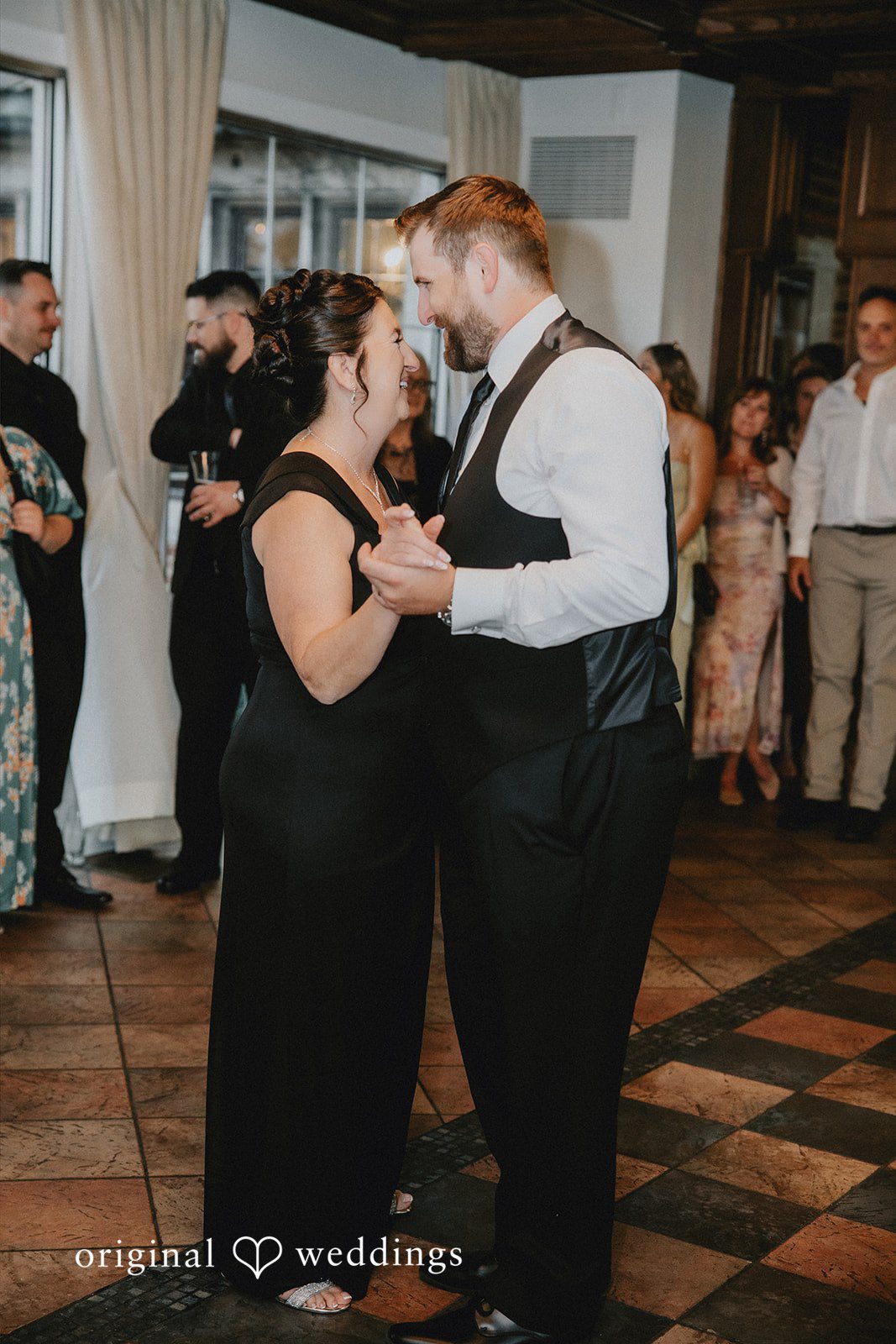 Man and woman dancing together at a wedding reception.