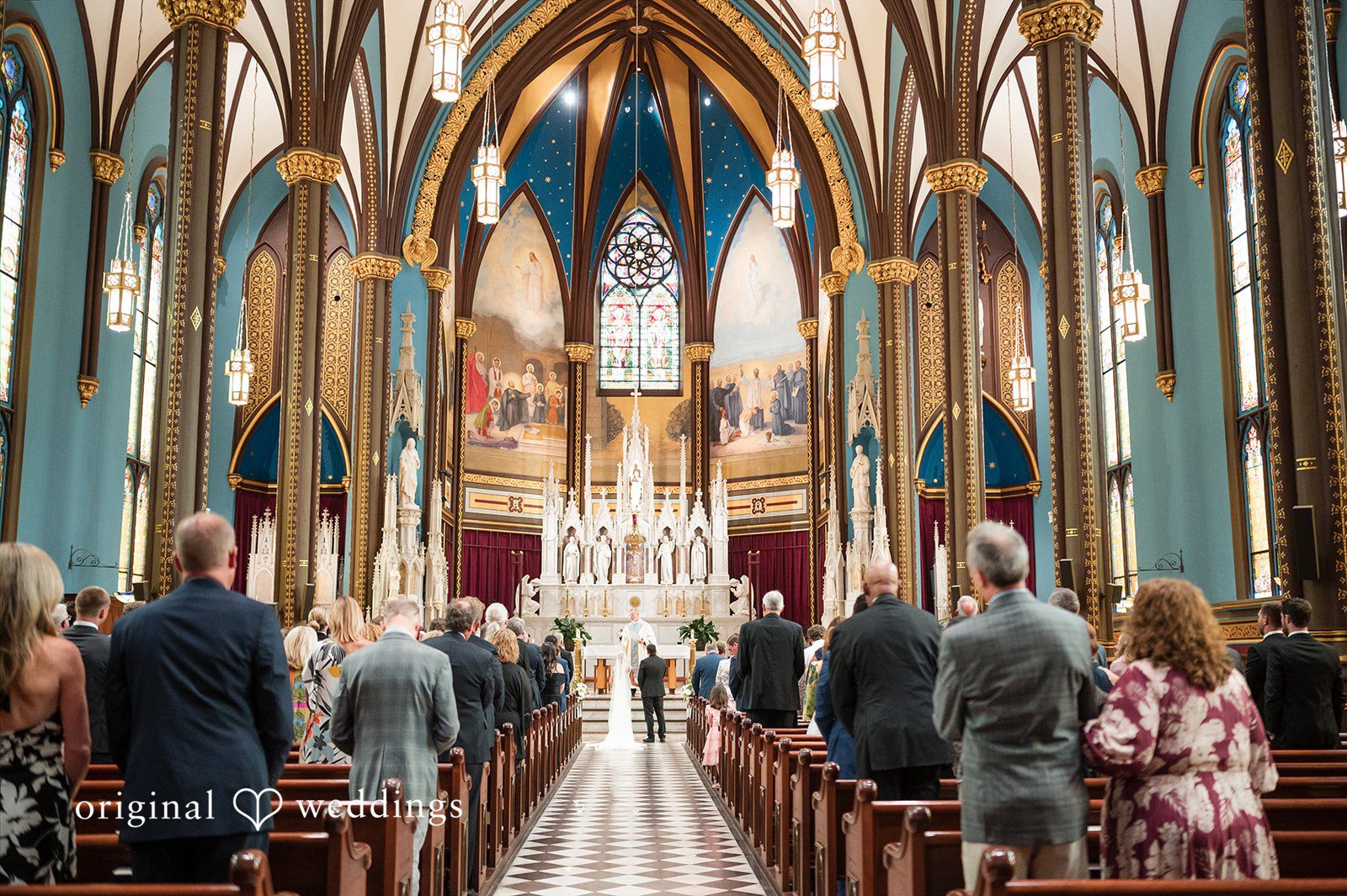 Church sanctuary filled with wedding guests facing toward the altar.