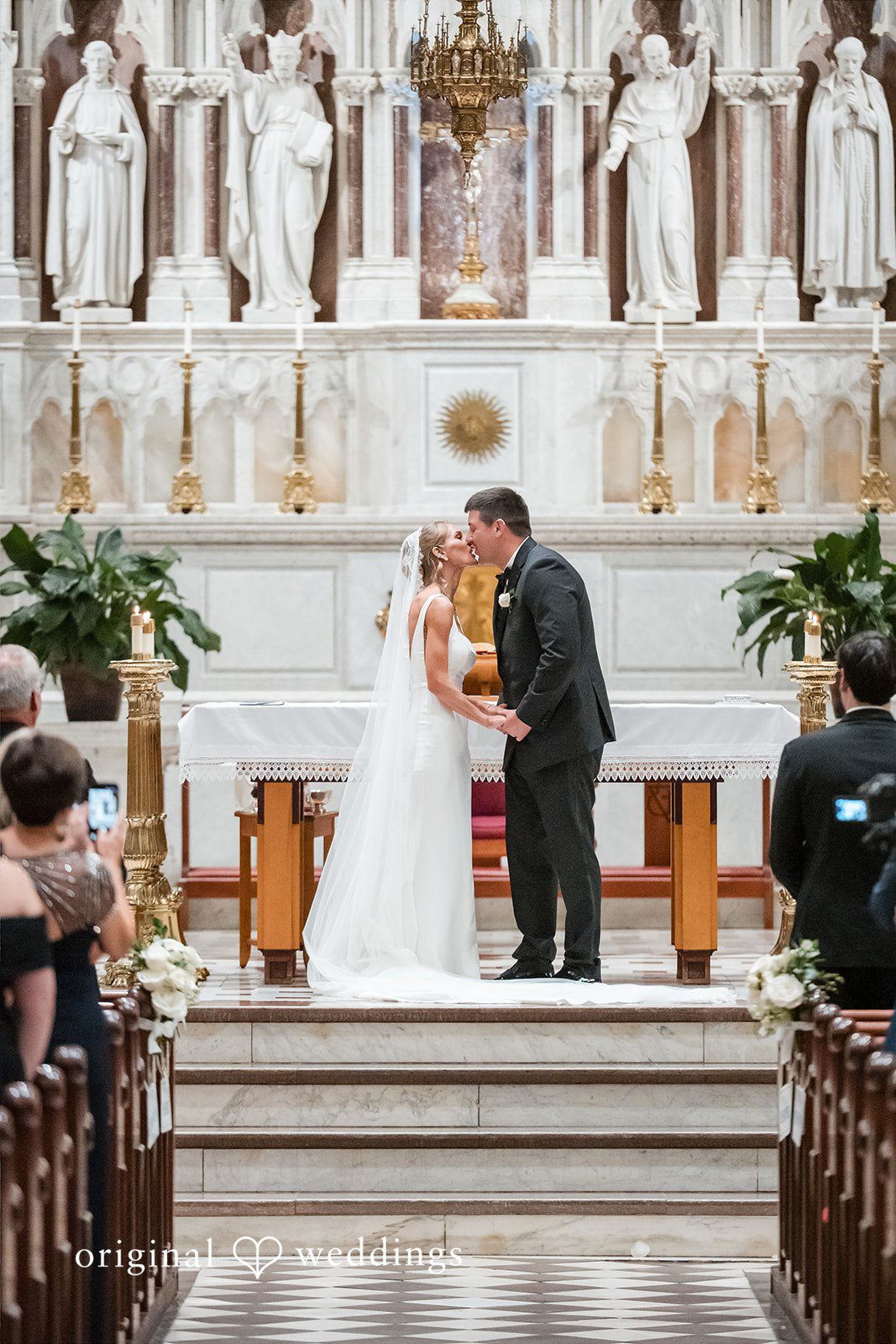 Bride and groom facing each other at the altar during their ceremony.