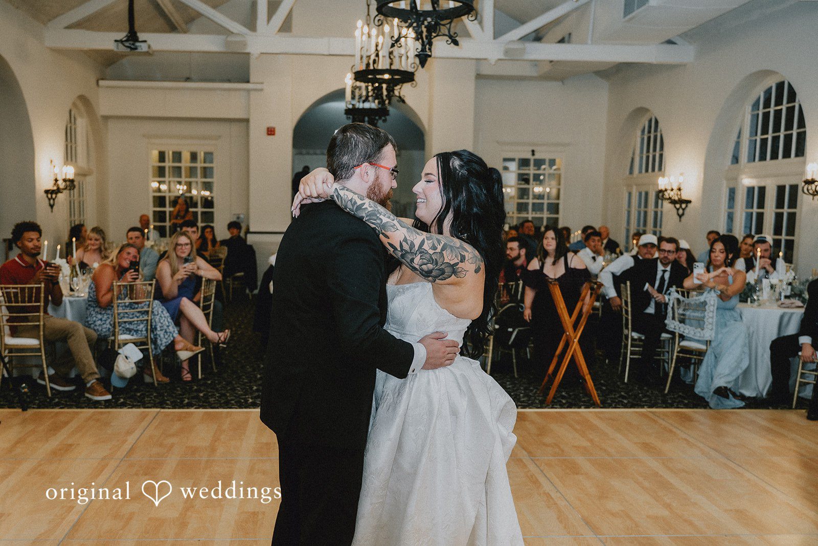 August 07, 2026 – Carly & Dillon – (ID-5065) A bride and groom sharing a romantic kiss in the middle of a dance floor.