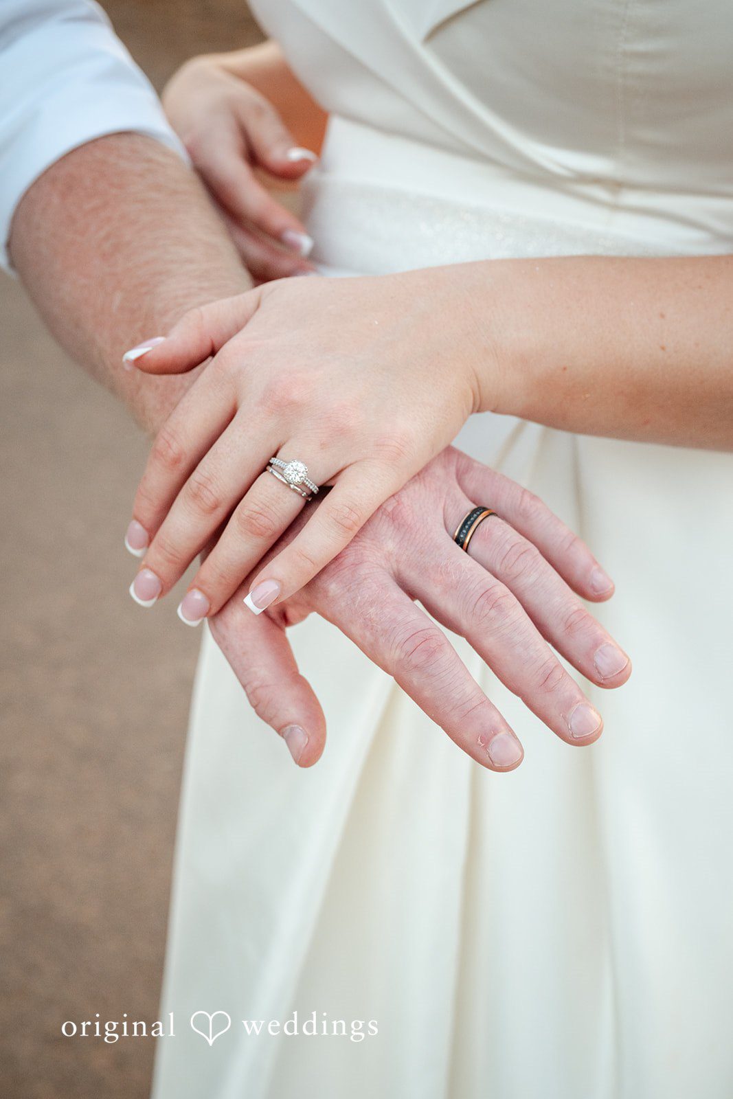 Victoria + Skyler Close-up of a couple's hands showing a wedding ring.