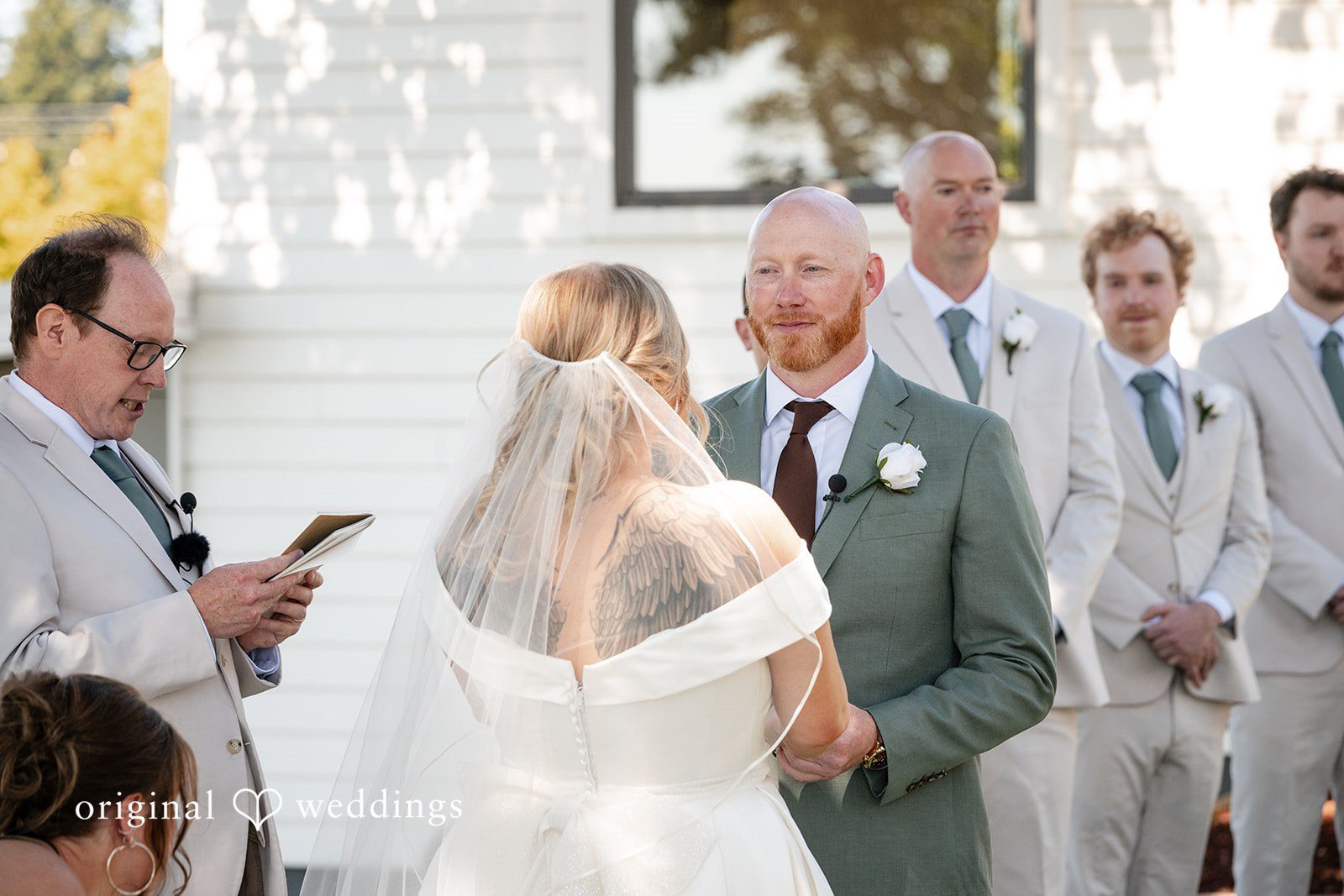 Victoria + Skyler Bride and groom facing each other at the altar during a ceremony.