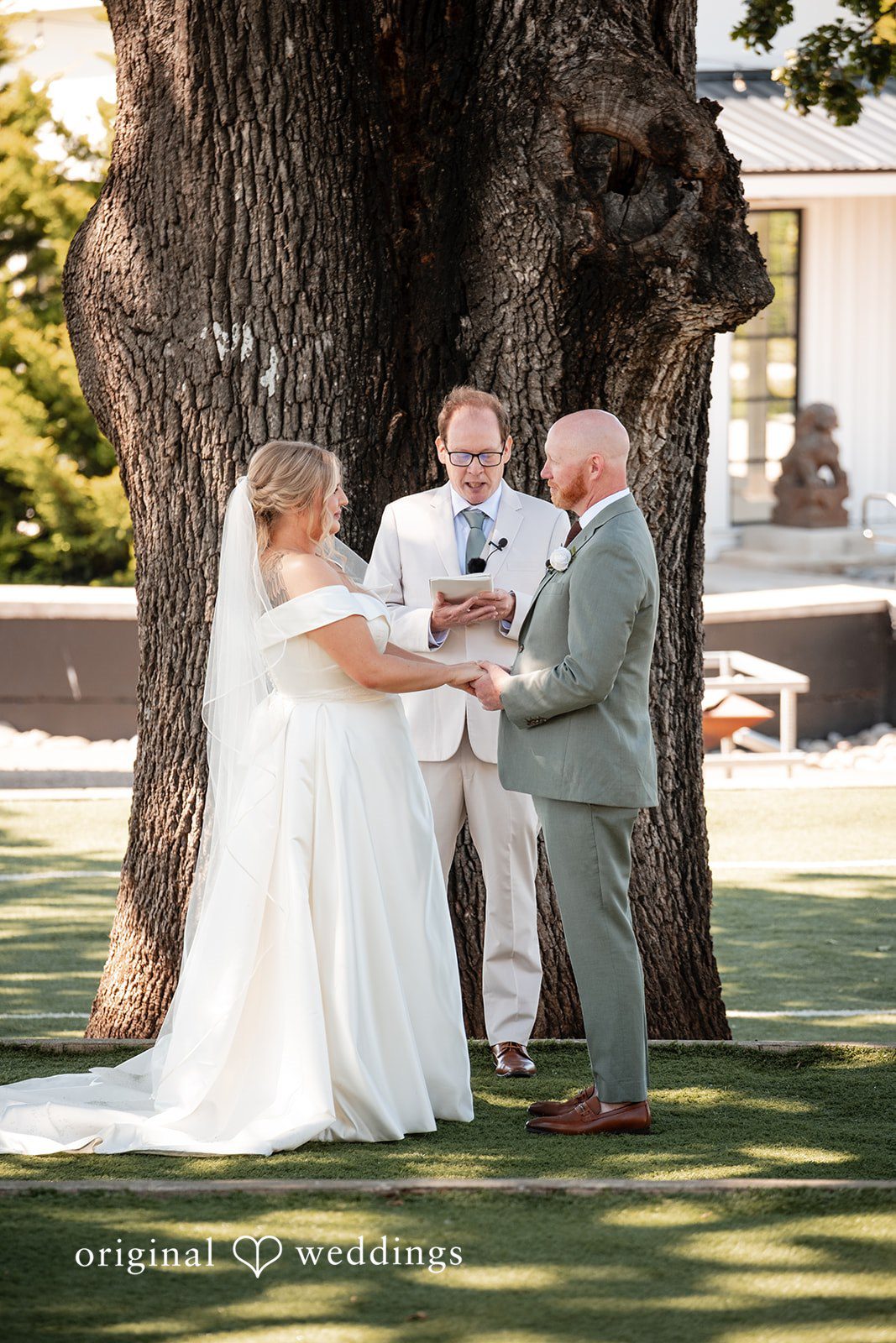 Victoria + Skyler Bride and groom standing before an officiant during their wedding.
