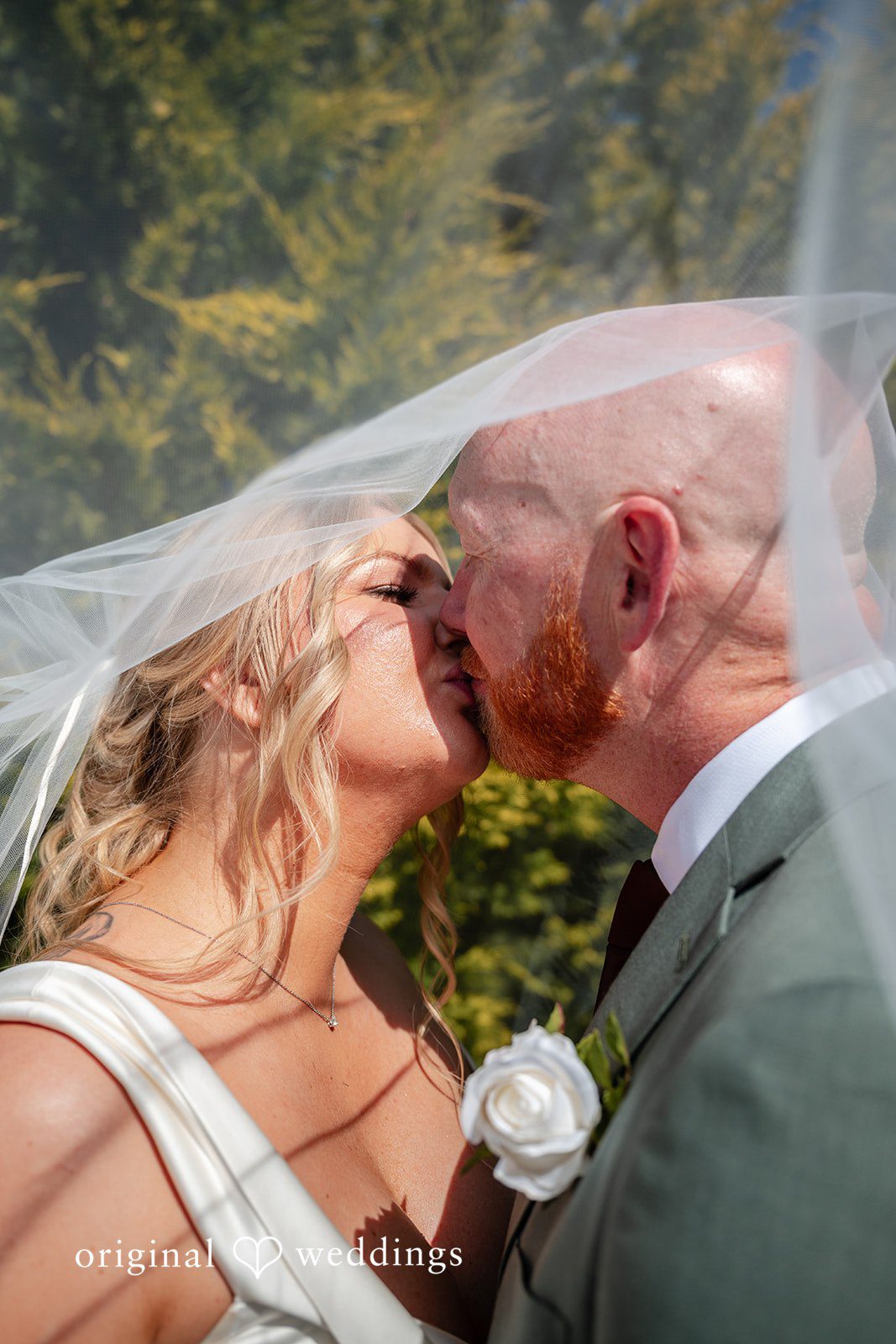 Victoria + Skyler Close-up shot of a bride and groom kissing with a soft overlay.