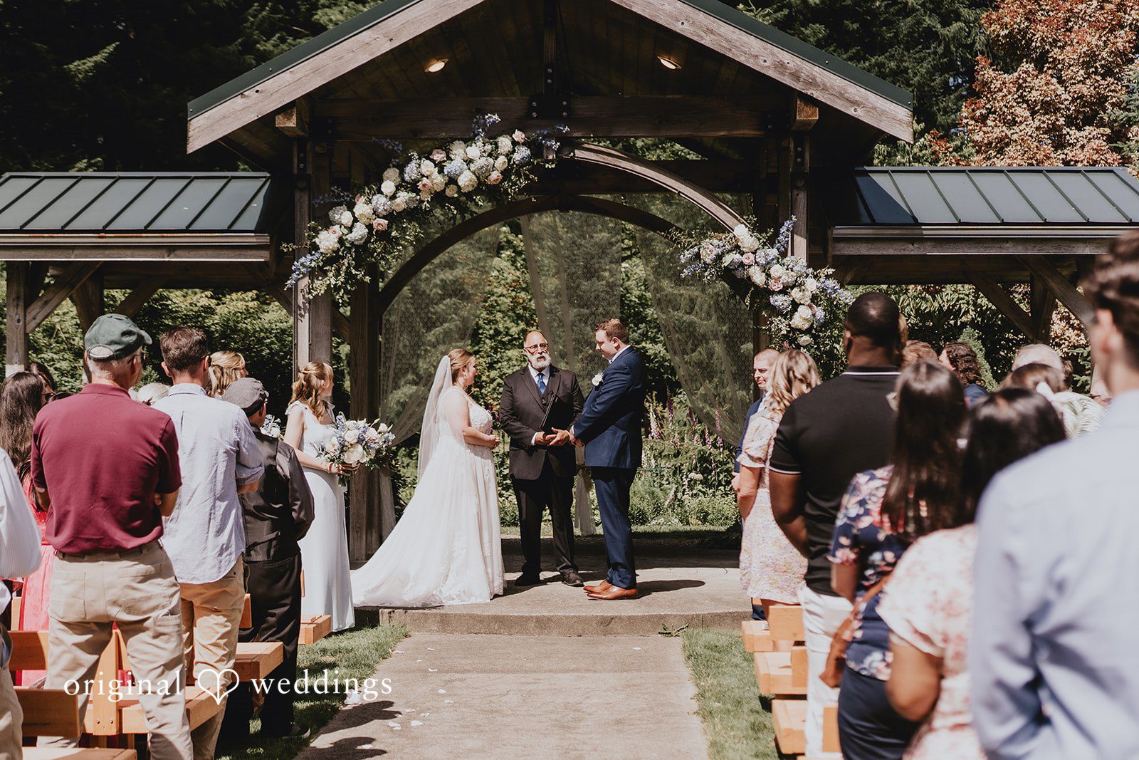 Natalie + DJ Bride and groom holding hands and exchanging vows during wedding ceremony