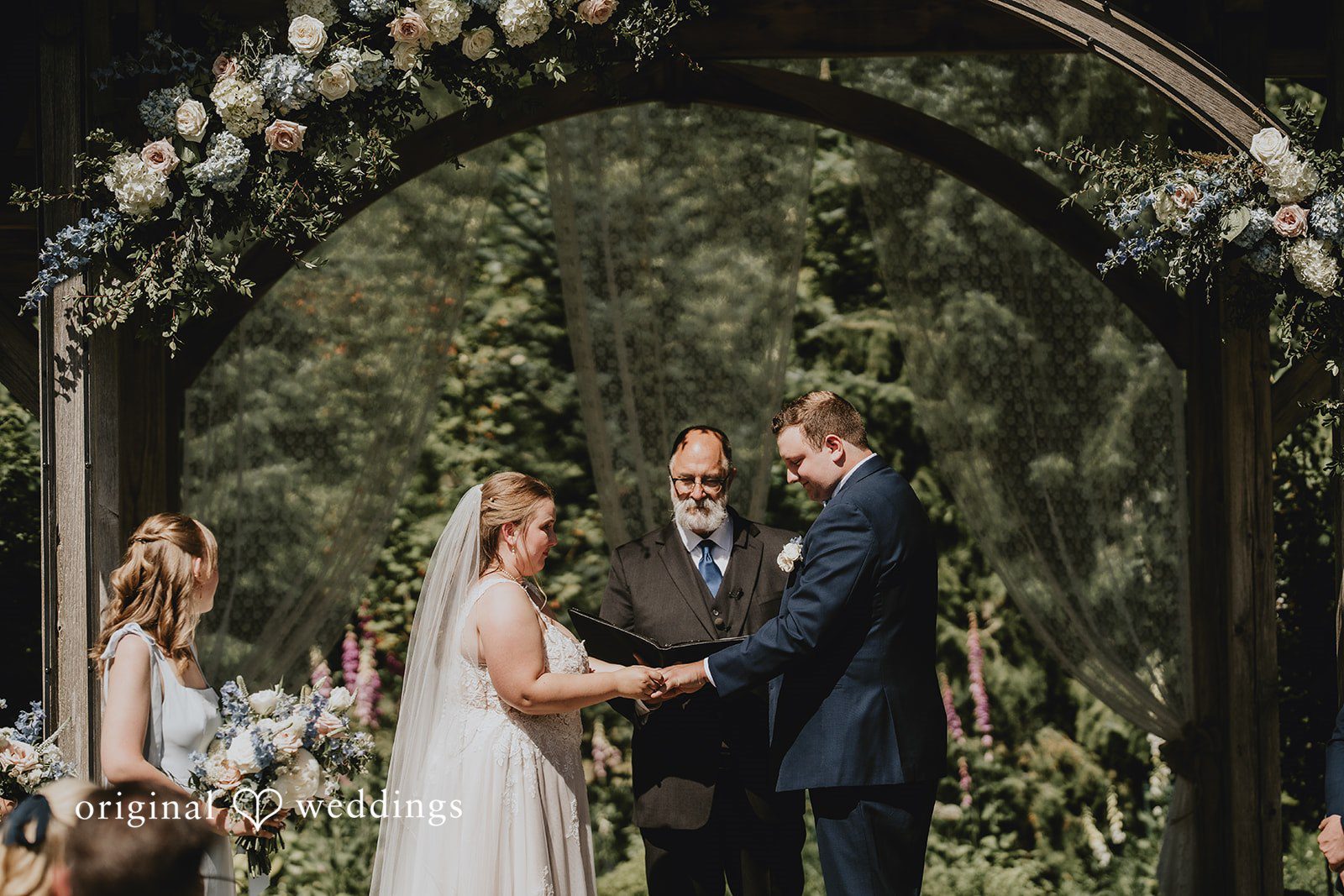 Natalie + DJ Bride and groom holding hands and exchanging vows during wedding ceremony