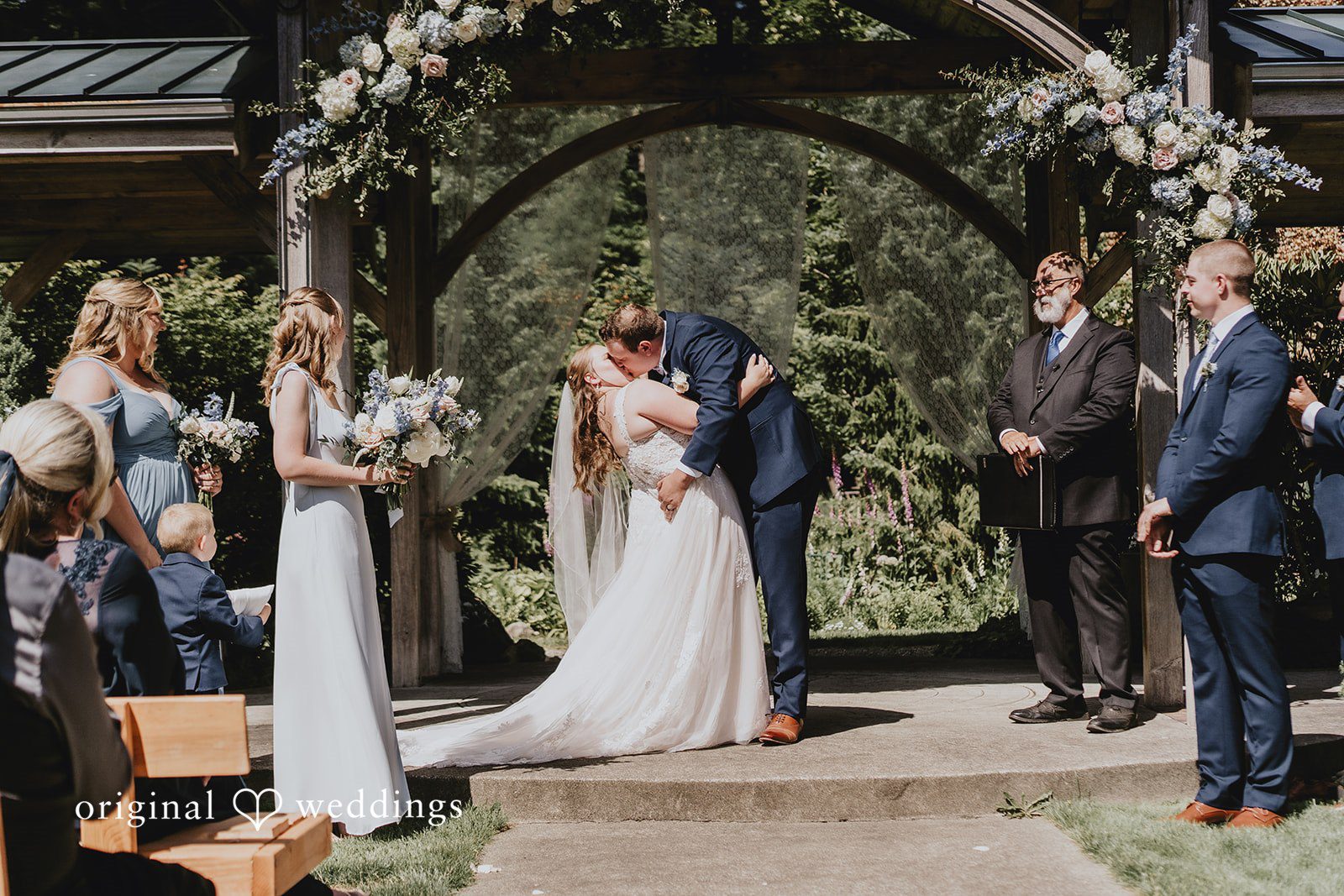 Natalie + DJ Bride and groom sharing a romantic first kiss during wedding ceremony at Rein Fire Ranch