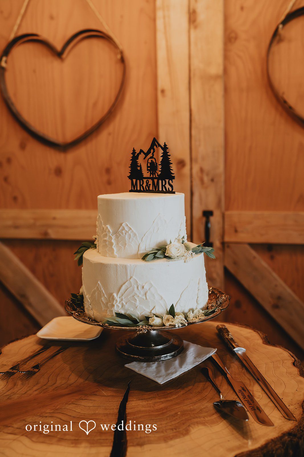 Natalie + DJ Beautiful picture of white wedding cake decorated with a cake topper