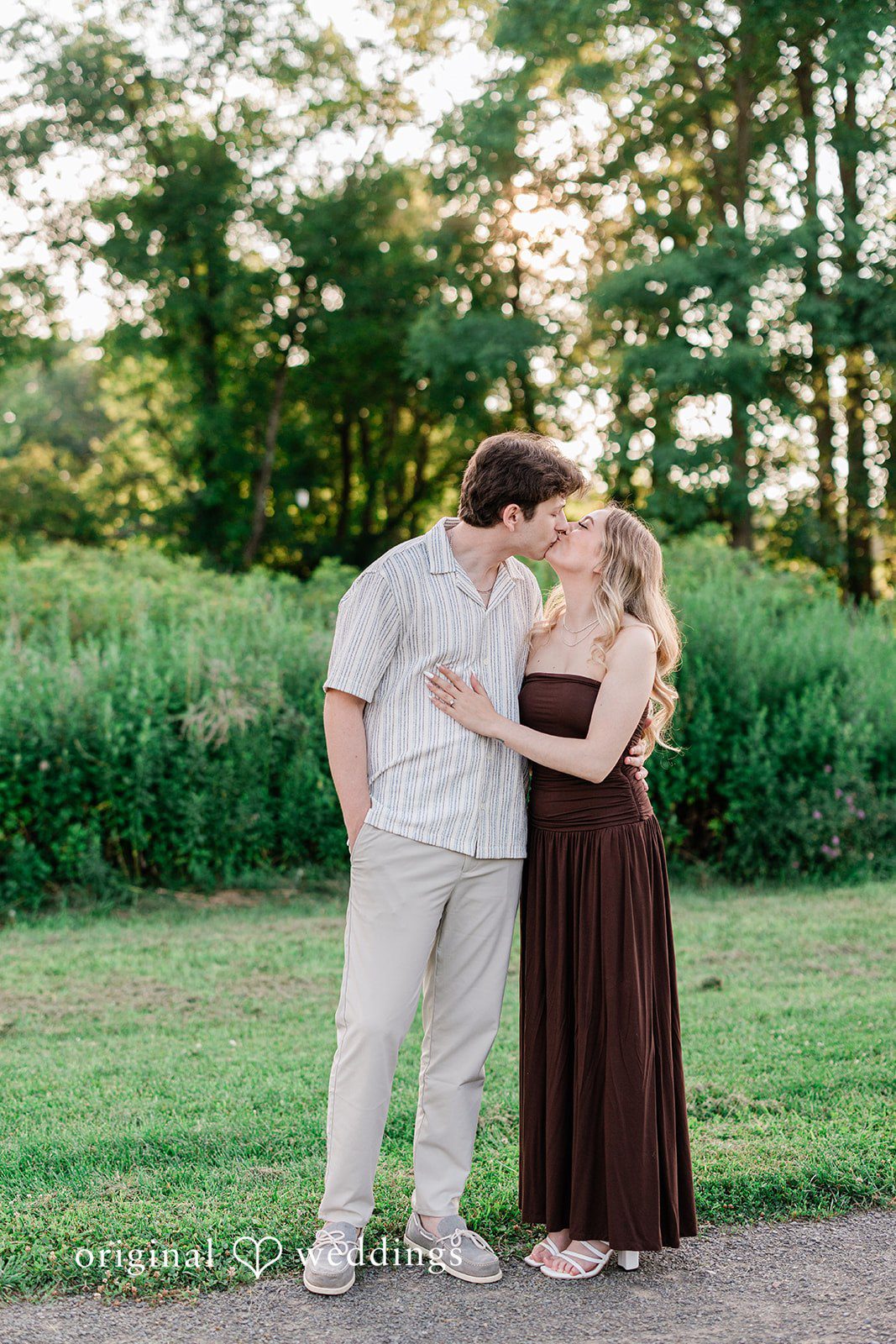 Sara + Jack A couple standing close together and kissing each other.