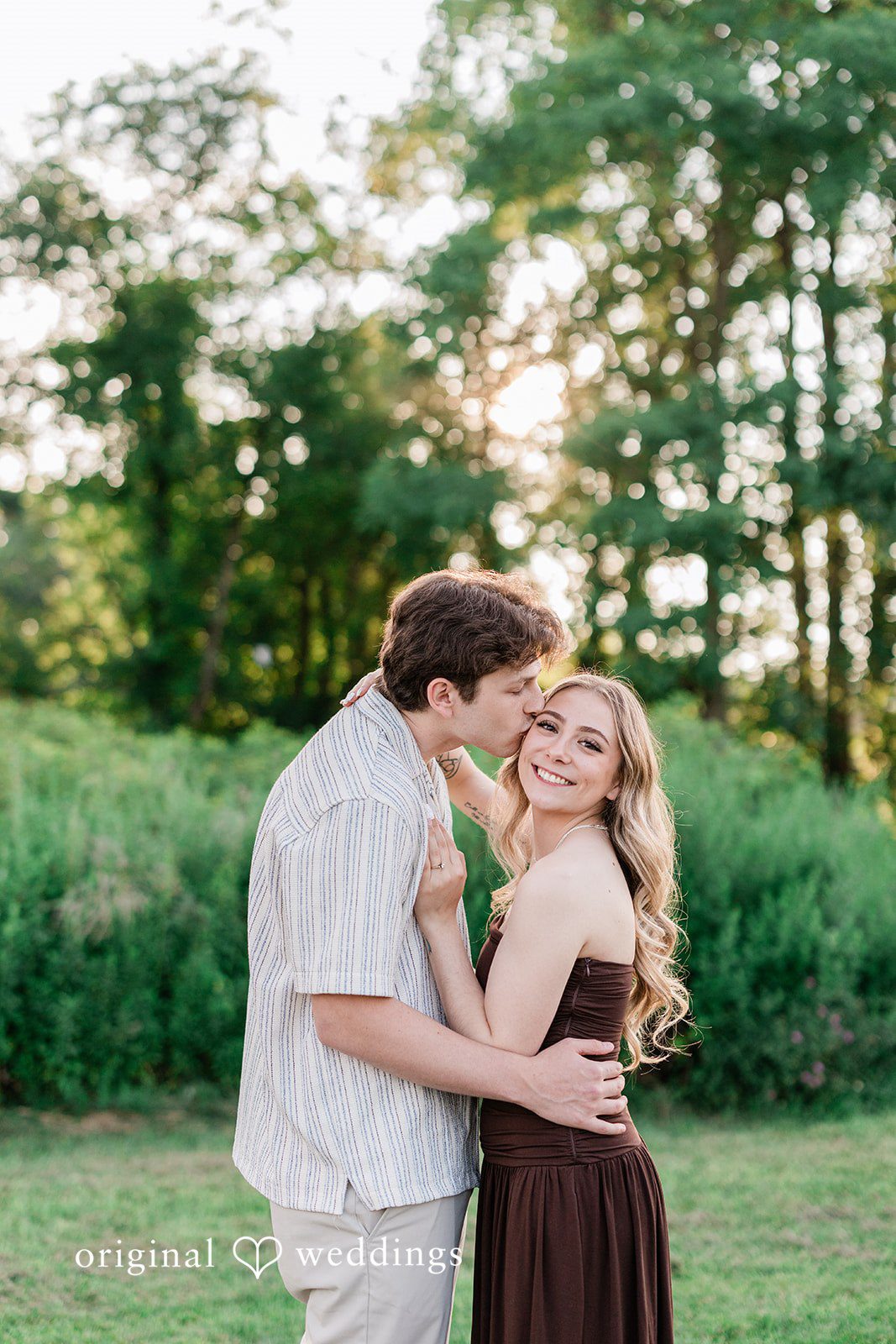 Sara + Jack A couple sharing a romantic embrace in a grassy setting.