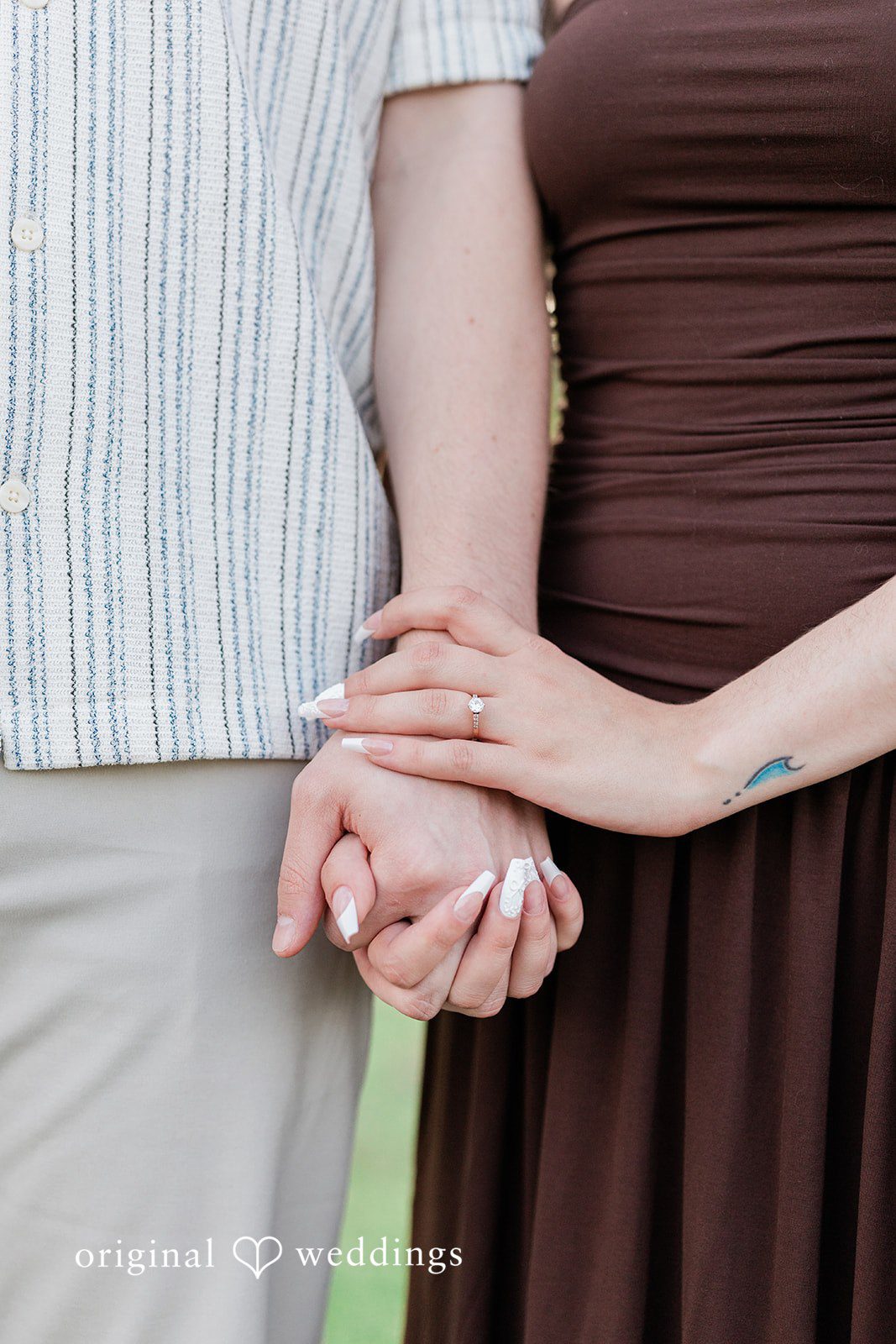 Sara + Jack A close-up shot of a couple standing close together and holding hands.