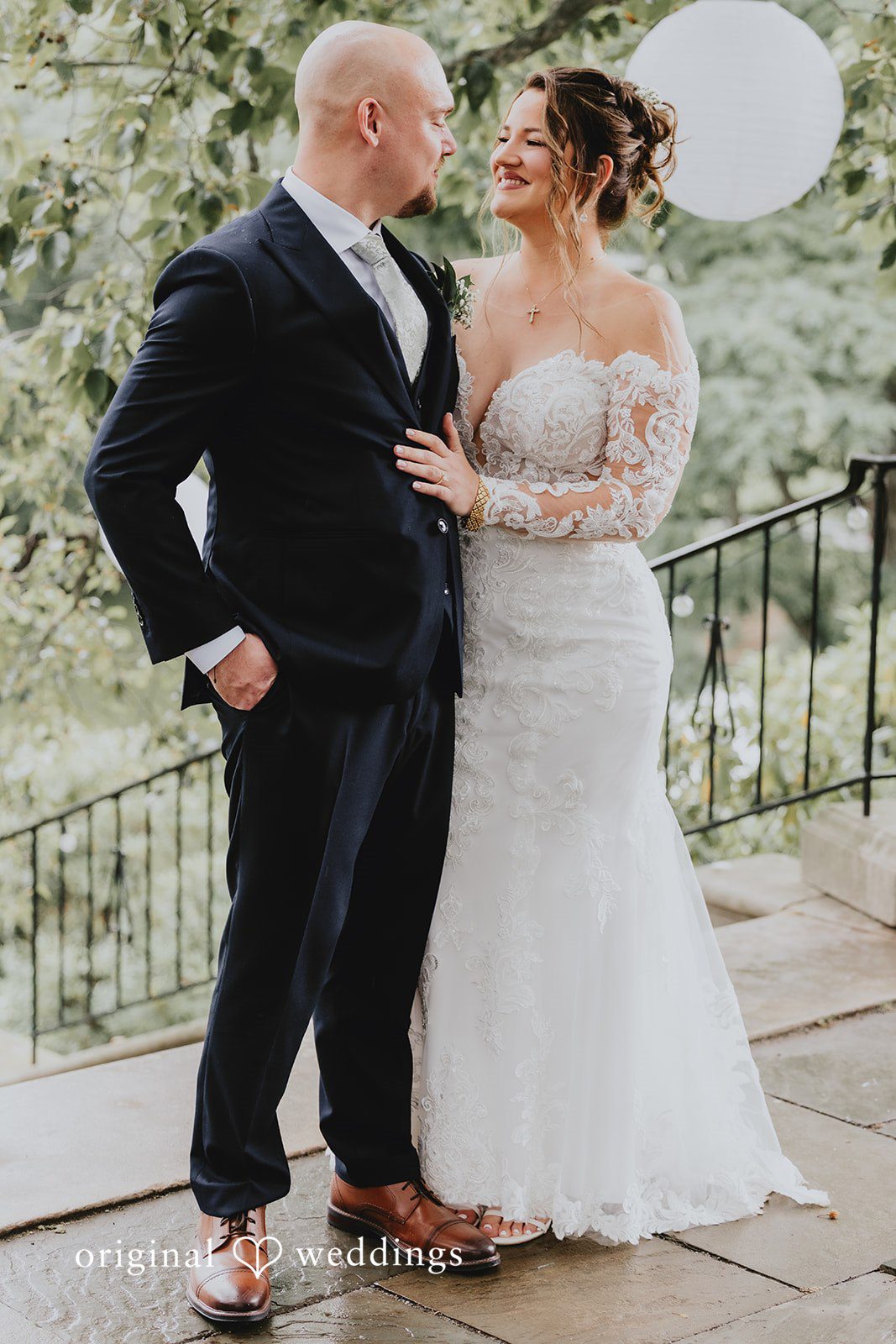 Samantha + Michael Bride and groom standing together and smiling on stone steps.