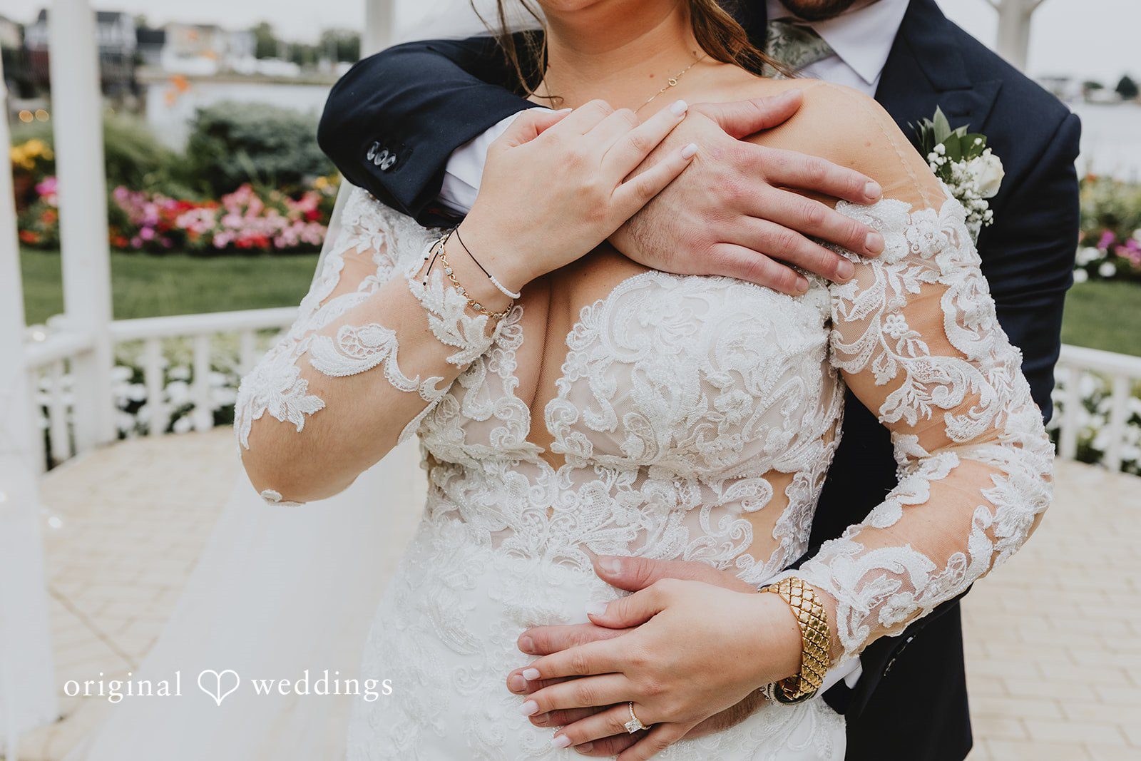 Samantha + Michael Close-up of a groom holding the bride from behind to show her lace dress details.