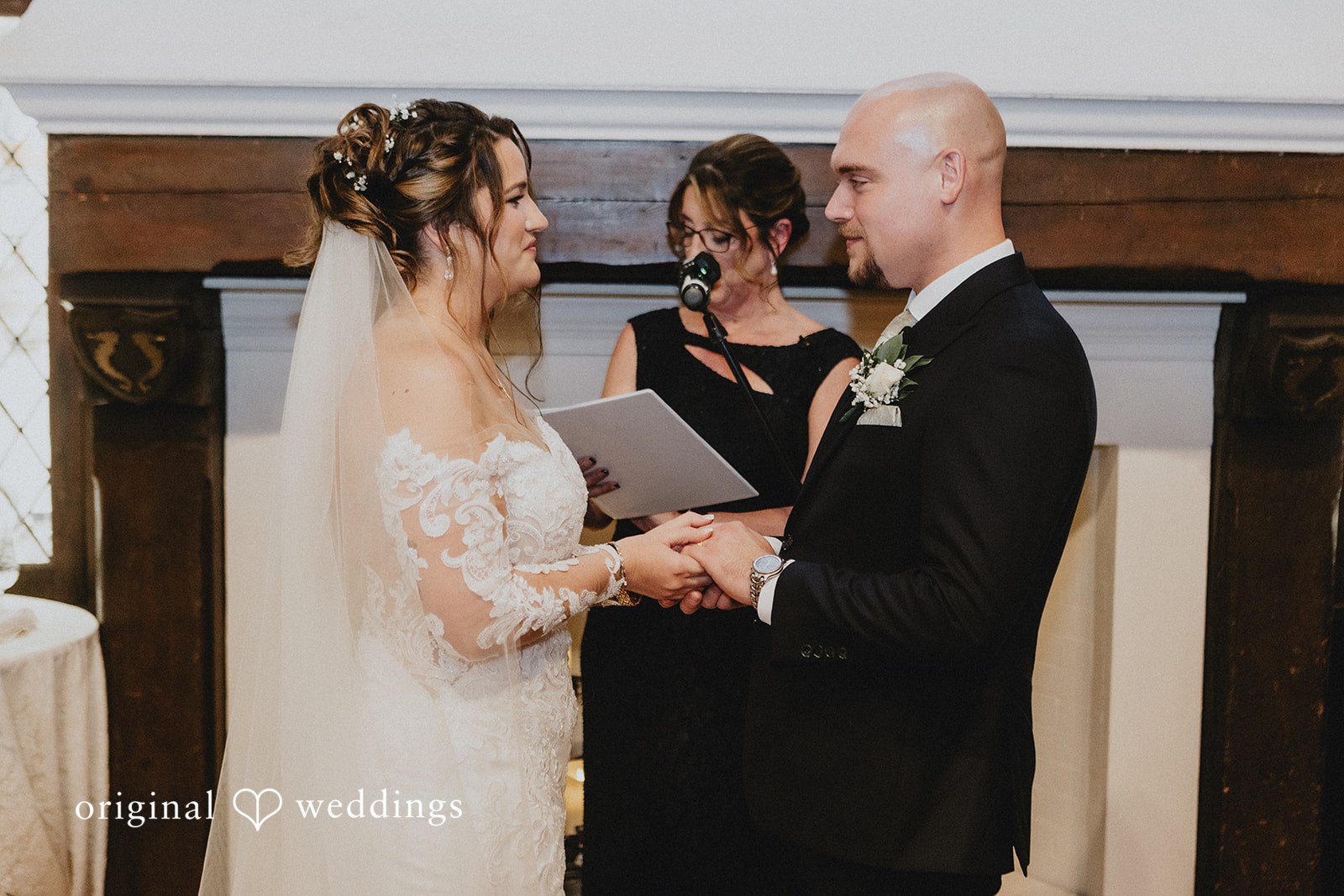 Samantha + Michael Bride and groom exchanging vows while holding hands at the altar.