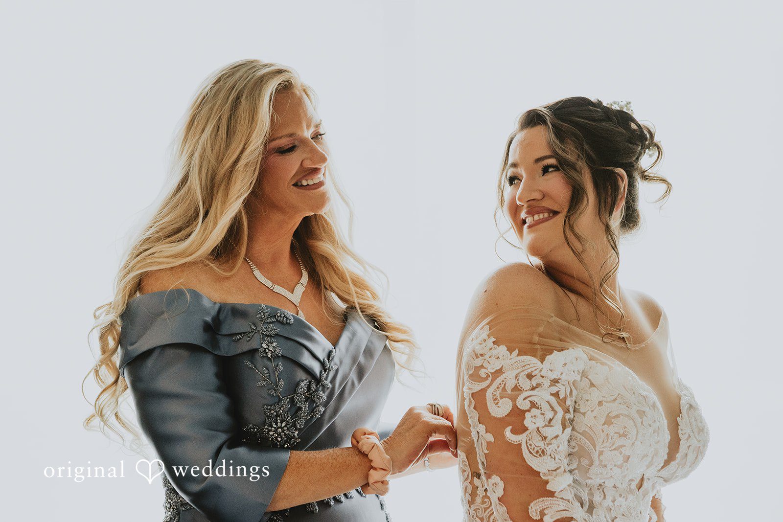 Samantha + Michael Two women sharing a joyful look before a wedding ceremony.