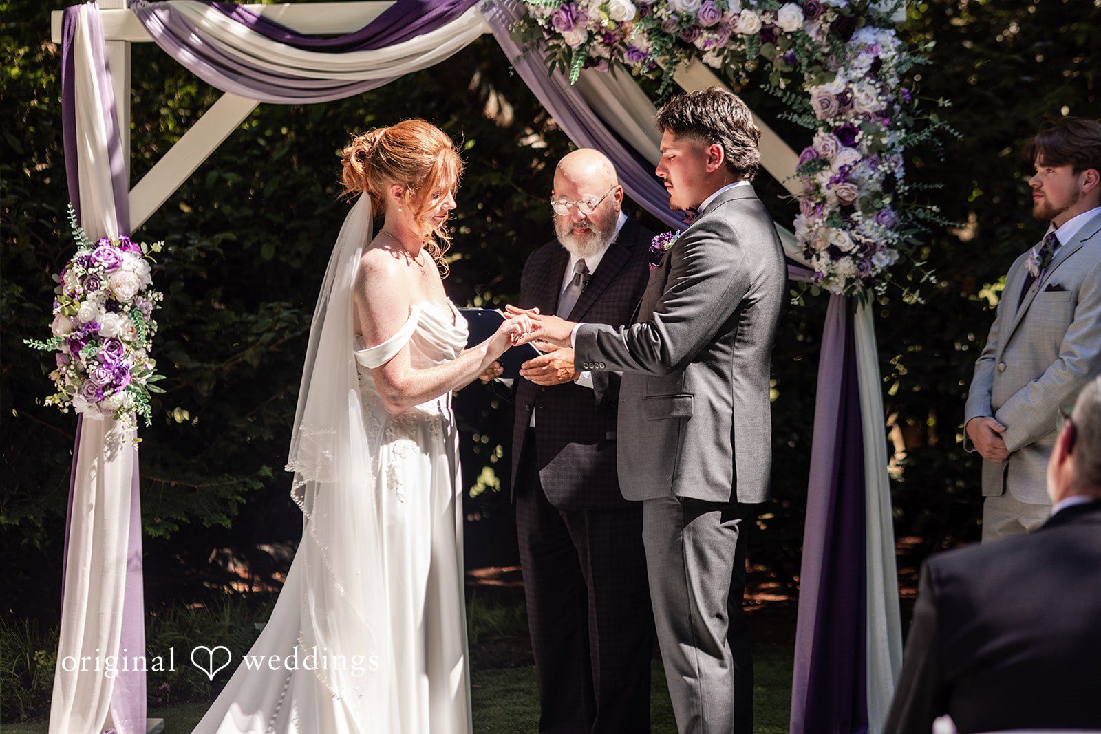 Victoria + Gabriel The bride puts a ring on groom’s finger