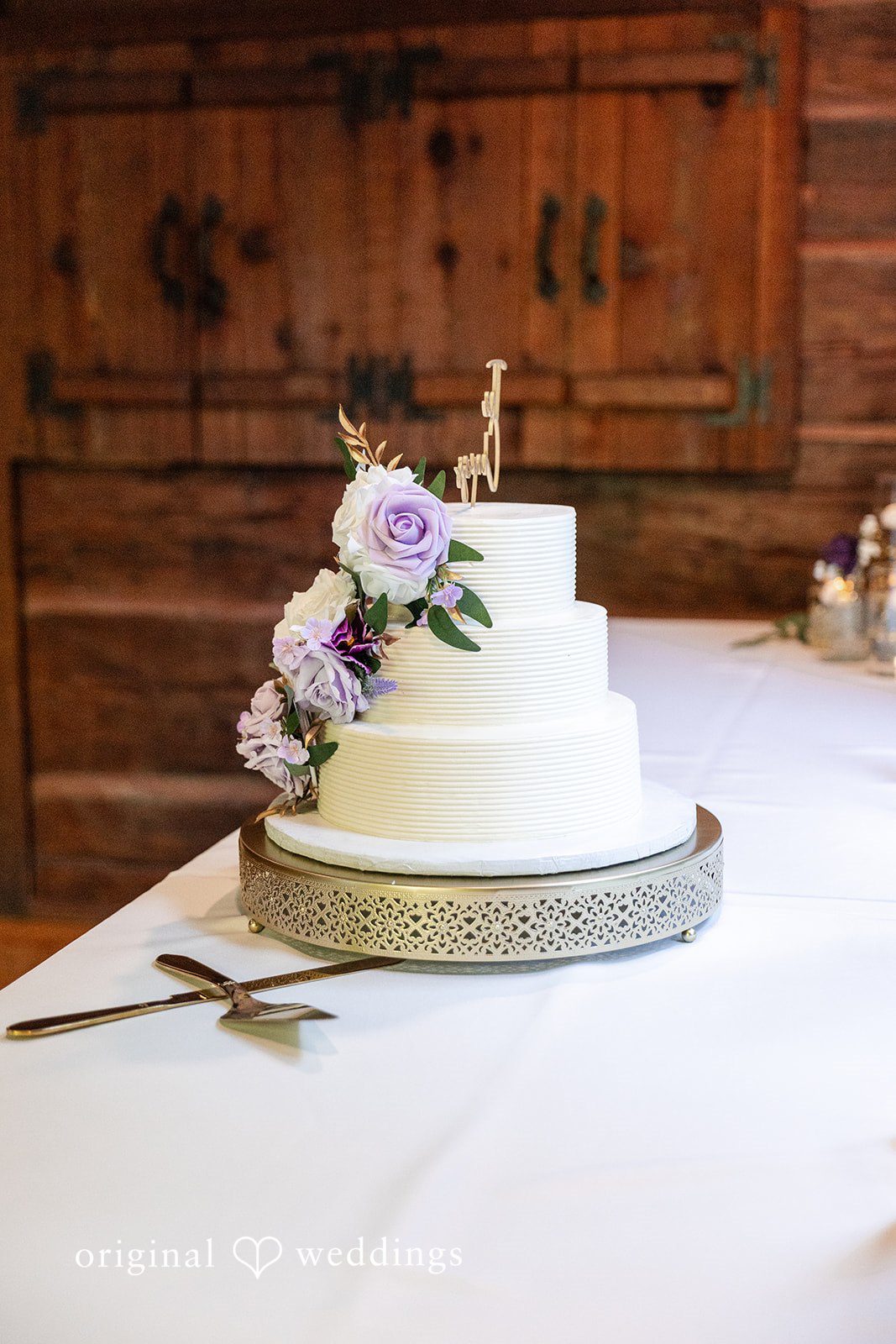 Victoria + Gabriel An all-white wedding cake adorned with fresh blooms
