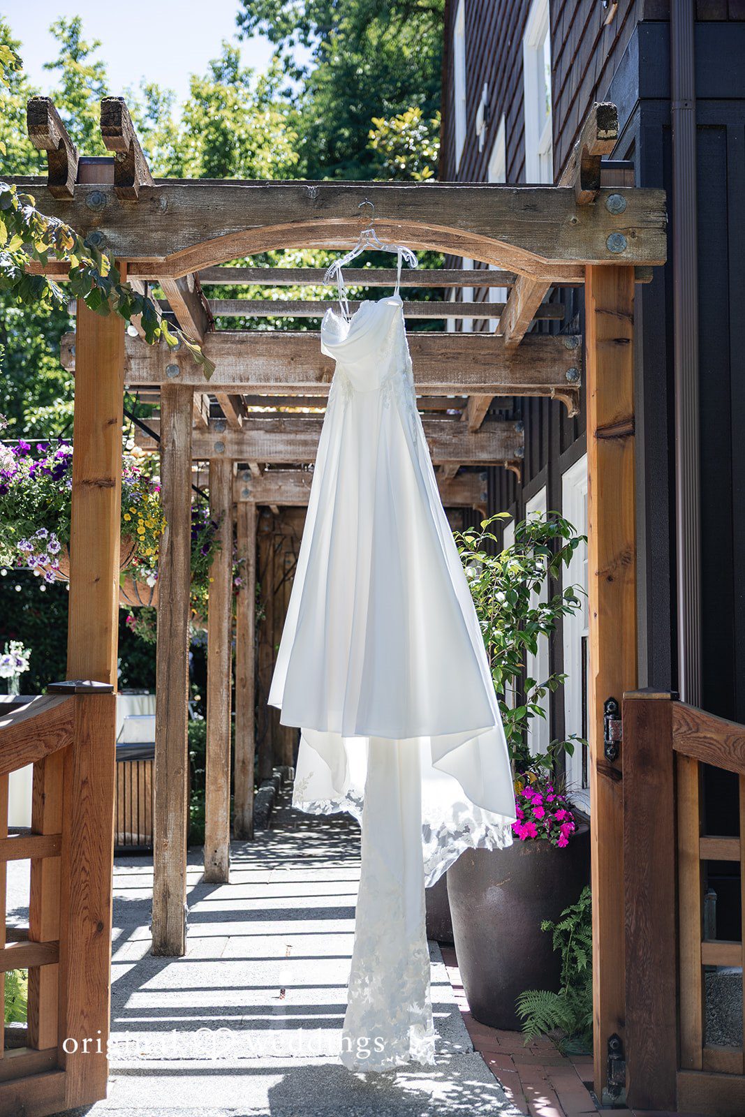 Victoria + Gabriel The bride's wedding gown gracefully hanging at Robinswood House