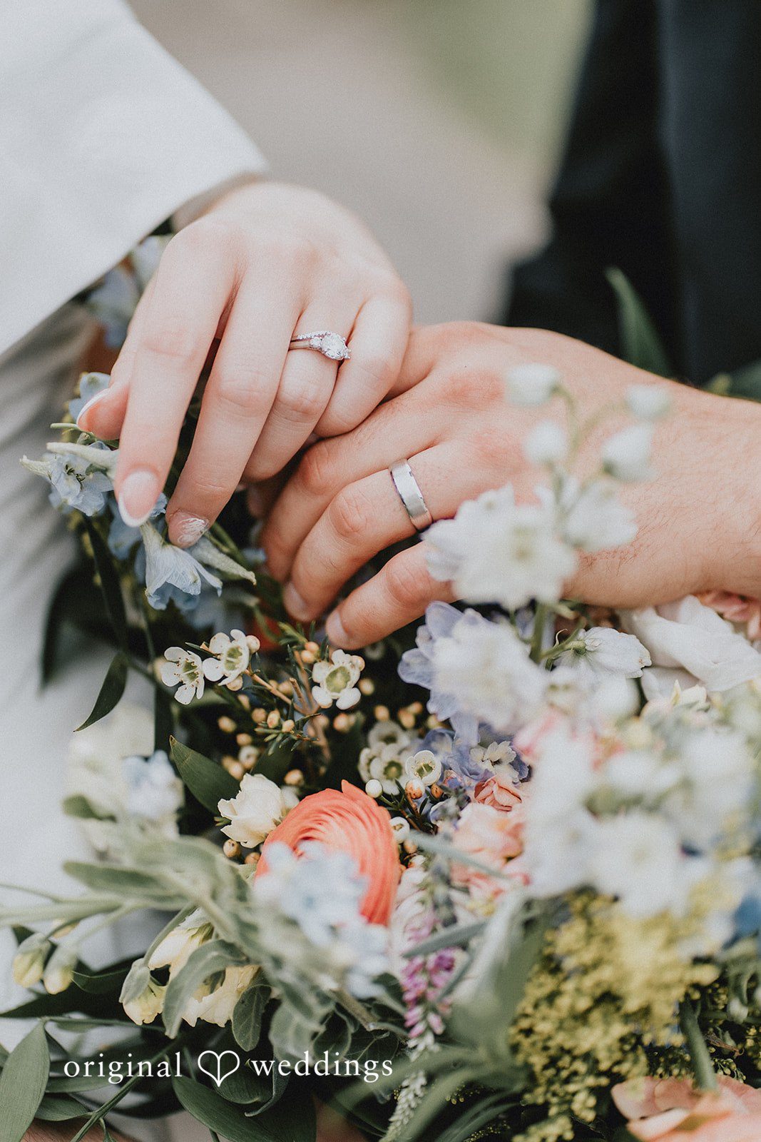 Brandon + Natalie Close-up of a bride's ringed hand resting on a floral bouquet.
