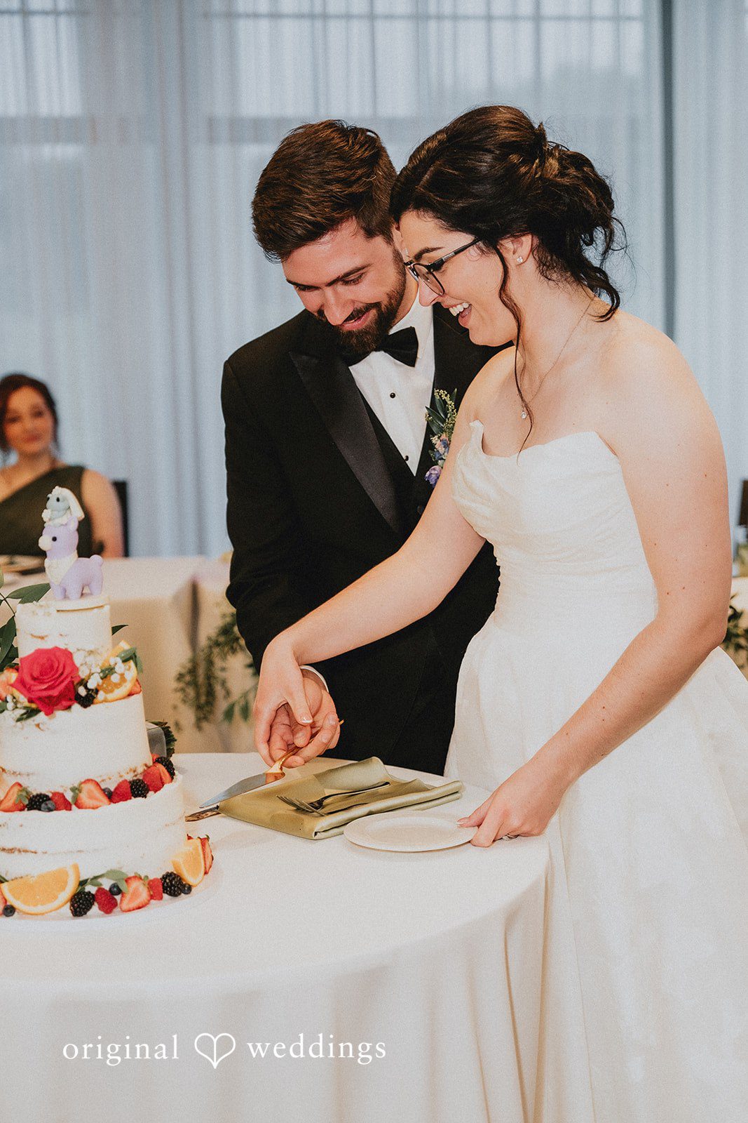 Brandon + Natalie A bride and groom cutting their wedding cake together.