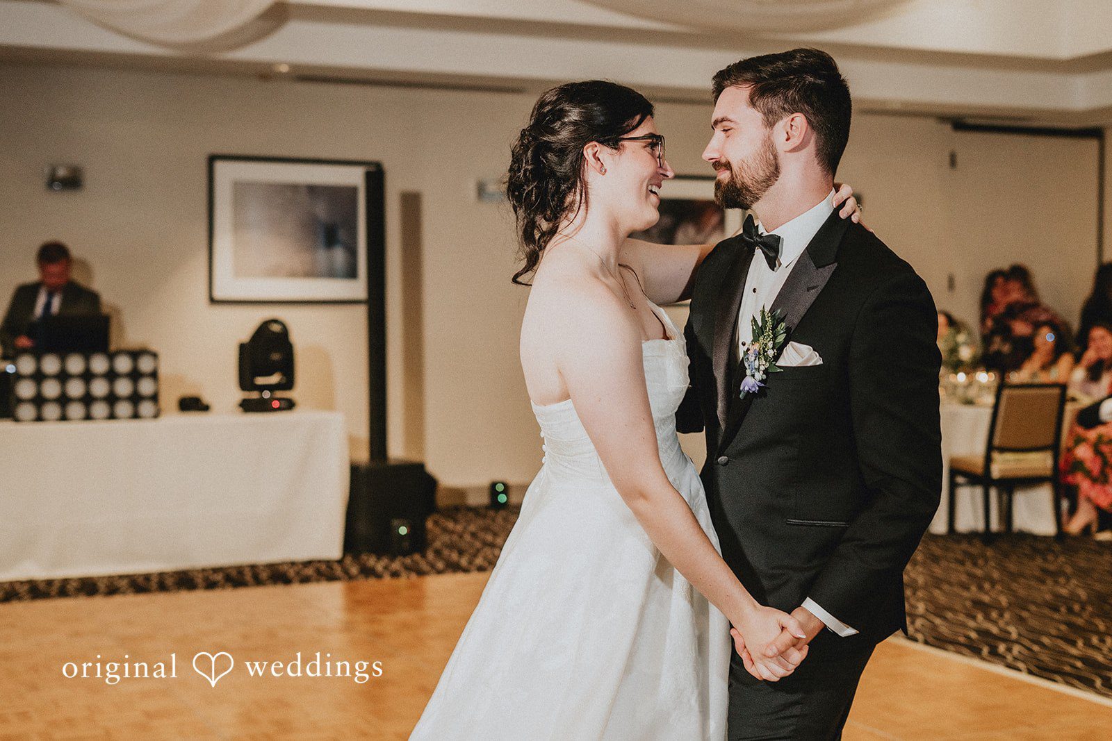 Brandon + Natalie A bride and groom looking at each other while dancing at their reception.