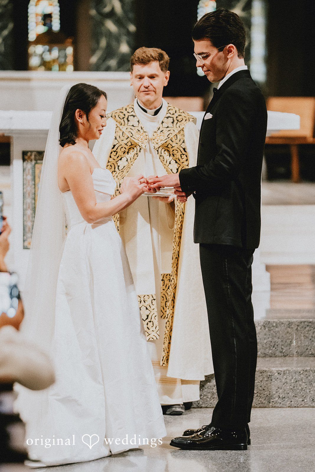 Aleksandar + Anna A bride and groom exchanging vows in front of an officiant.