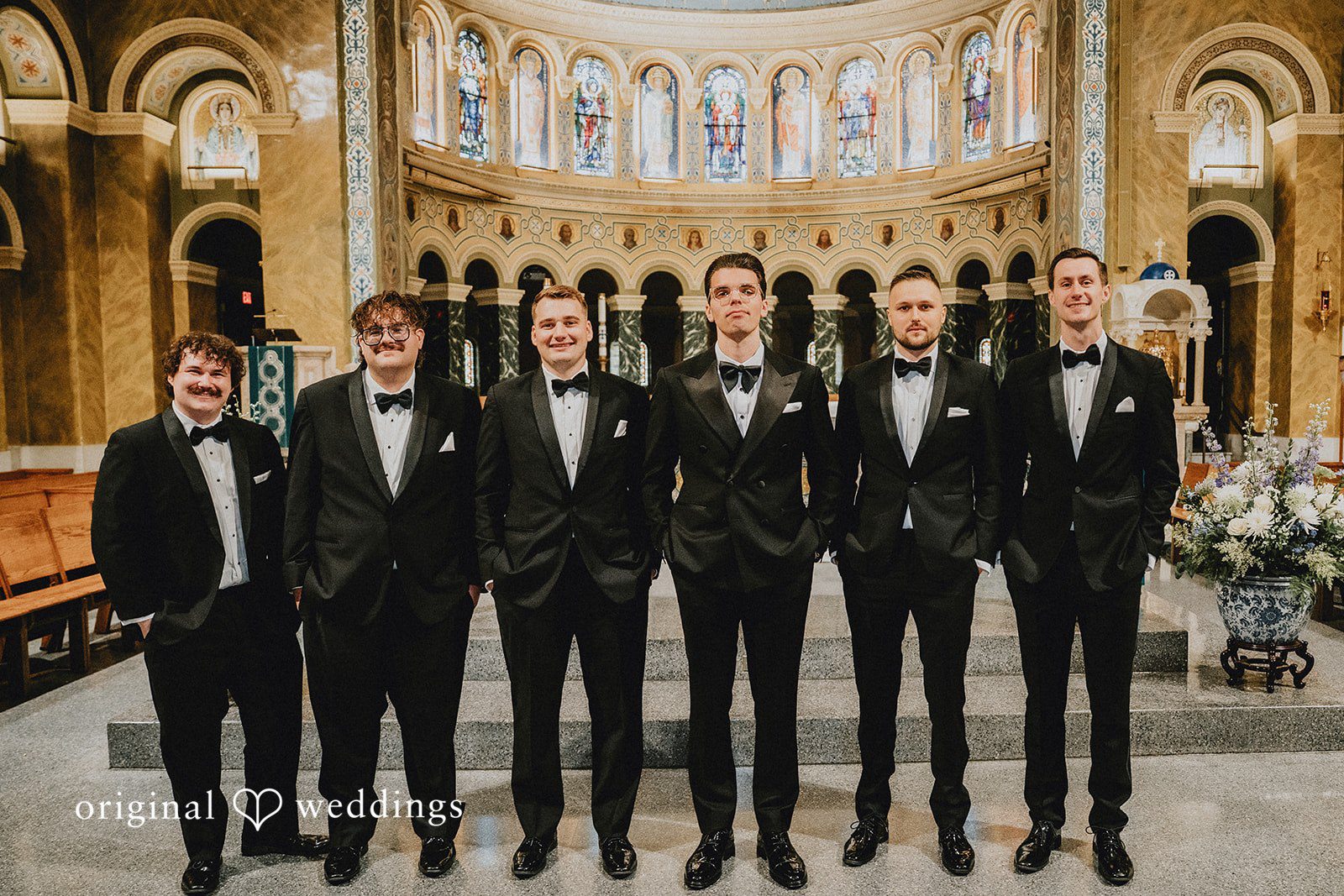 Aleksandar + Anna A groom standing together with his groomsmen in matching black tuxedos.