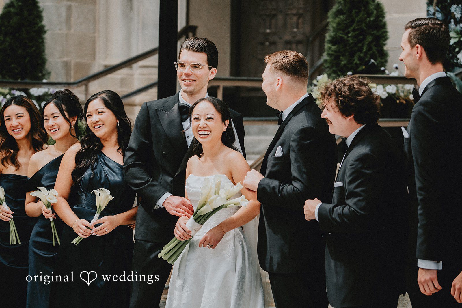 Aleksandar + Anna A bride holding her bouquet while surrounded by her wedding party.