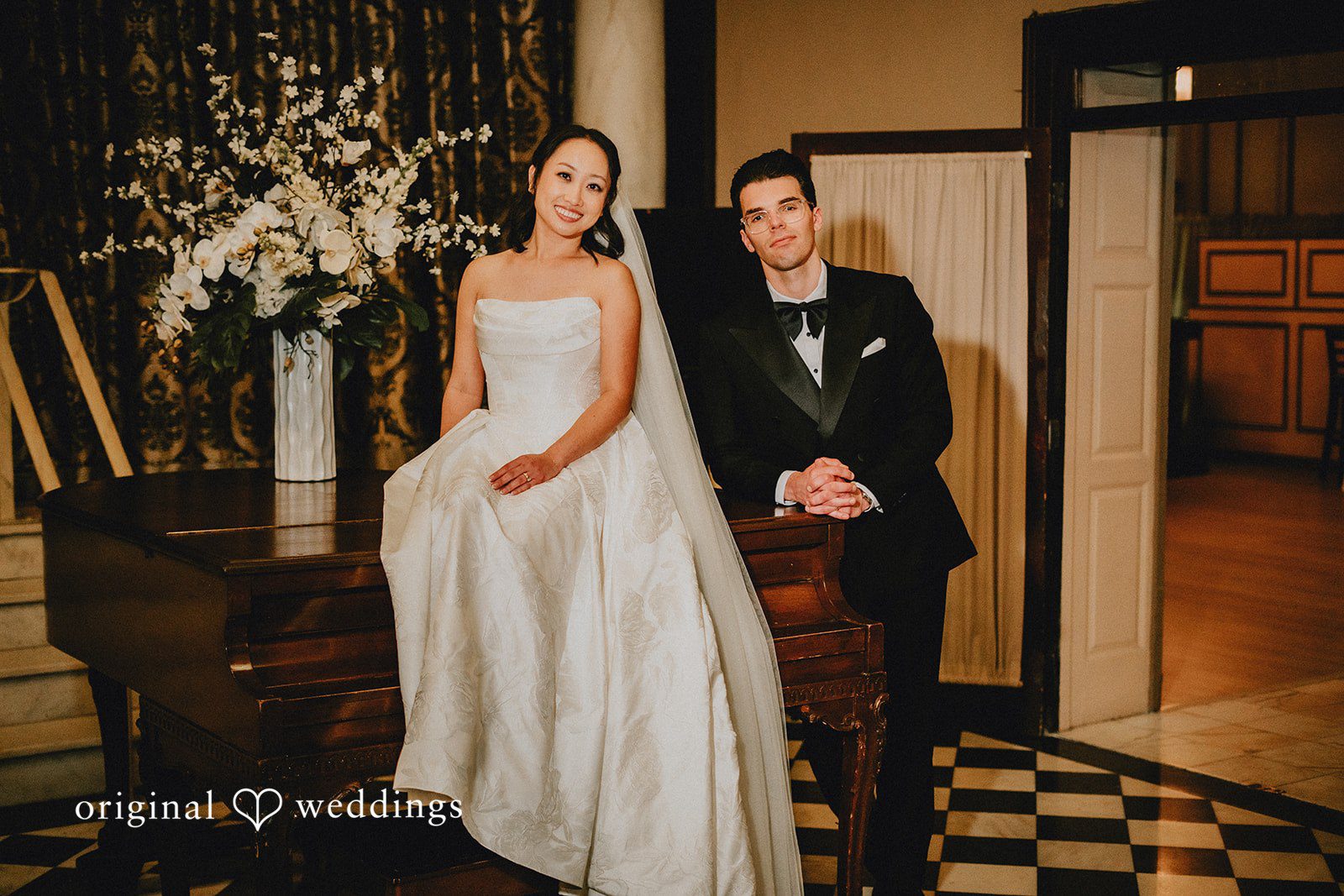 Aleksandar + Anna A bride and groom posing together by a decorated fireplace mantle