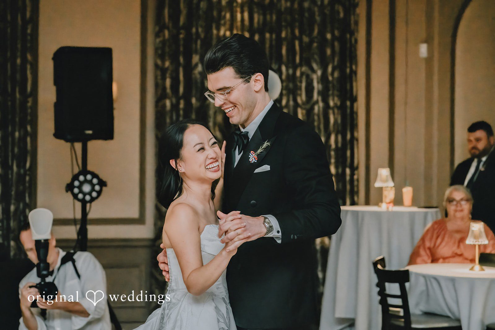 Aleksandar + Anna A bride and groom smiling and dancing together during their wedding reception.