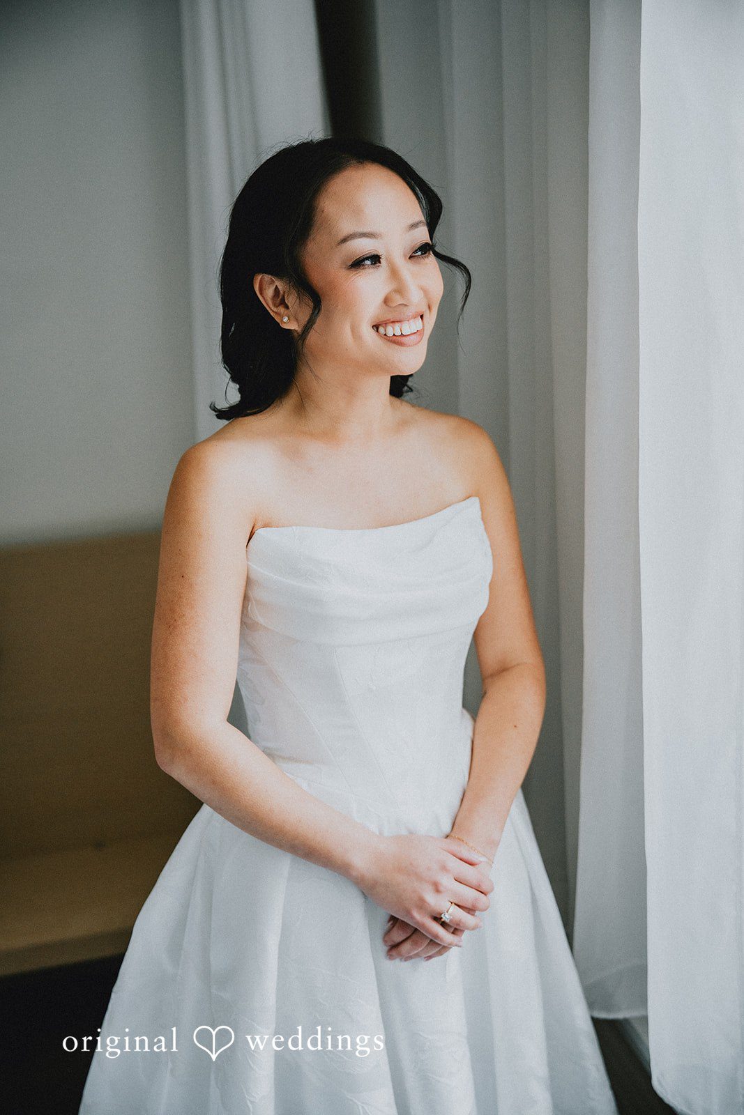 Aleksandar + Anna A bride in her wedding dress smiling warmly for a portrait.