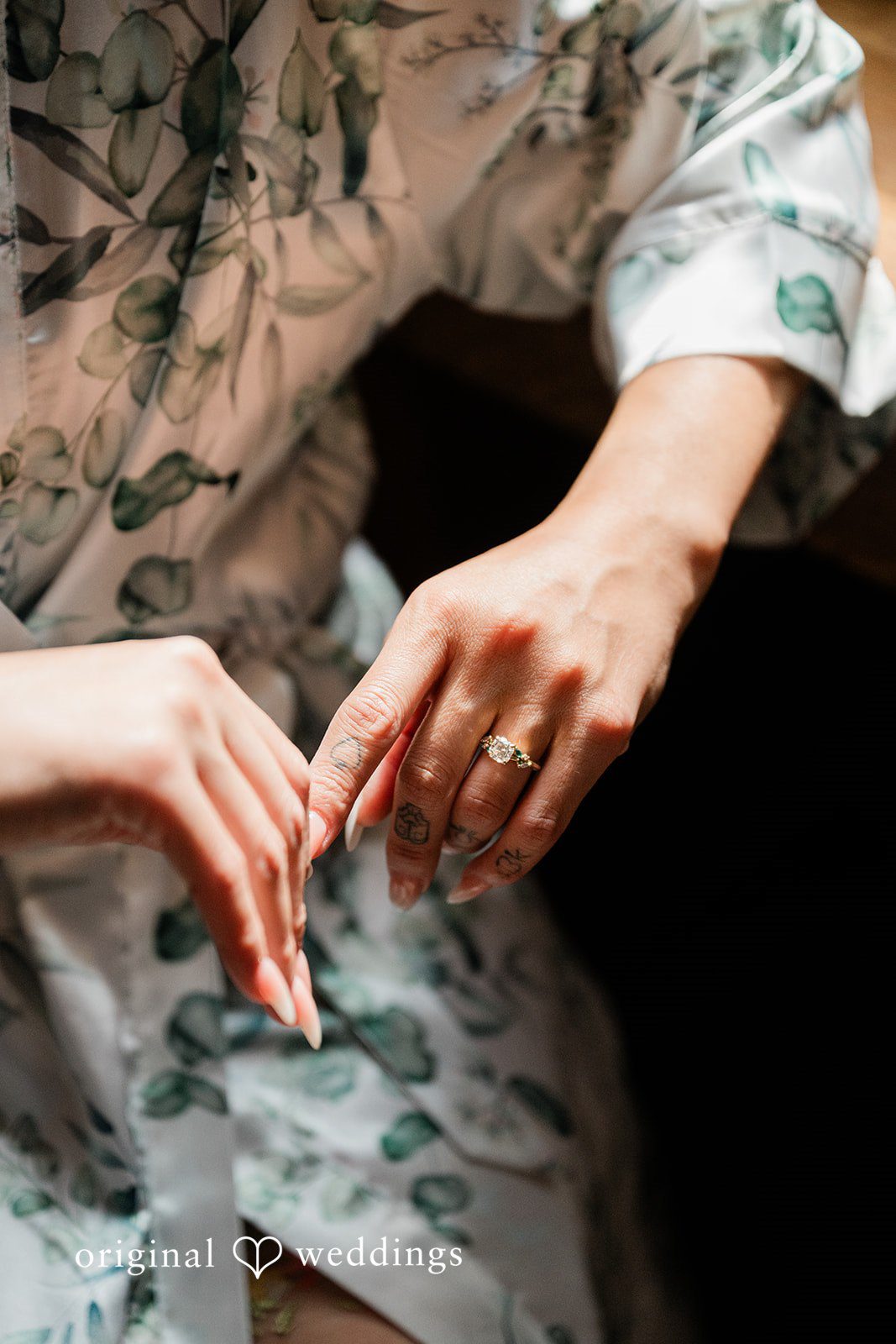 Lauren + Brinton Close-up of hands clasped together, highlighting rings.