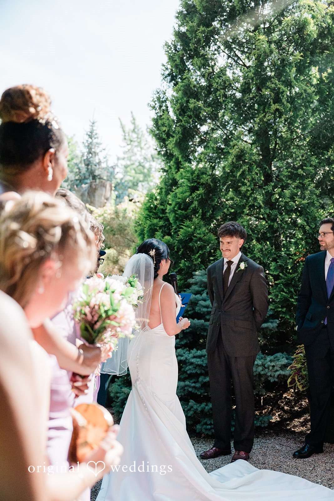 Lauren + Brinton A bride walking down an aisle towards a group of seated guests.