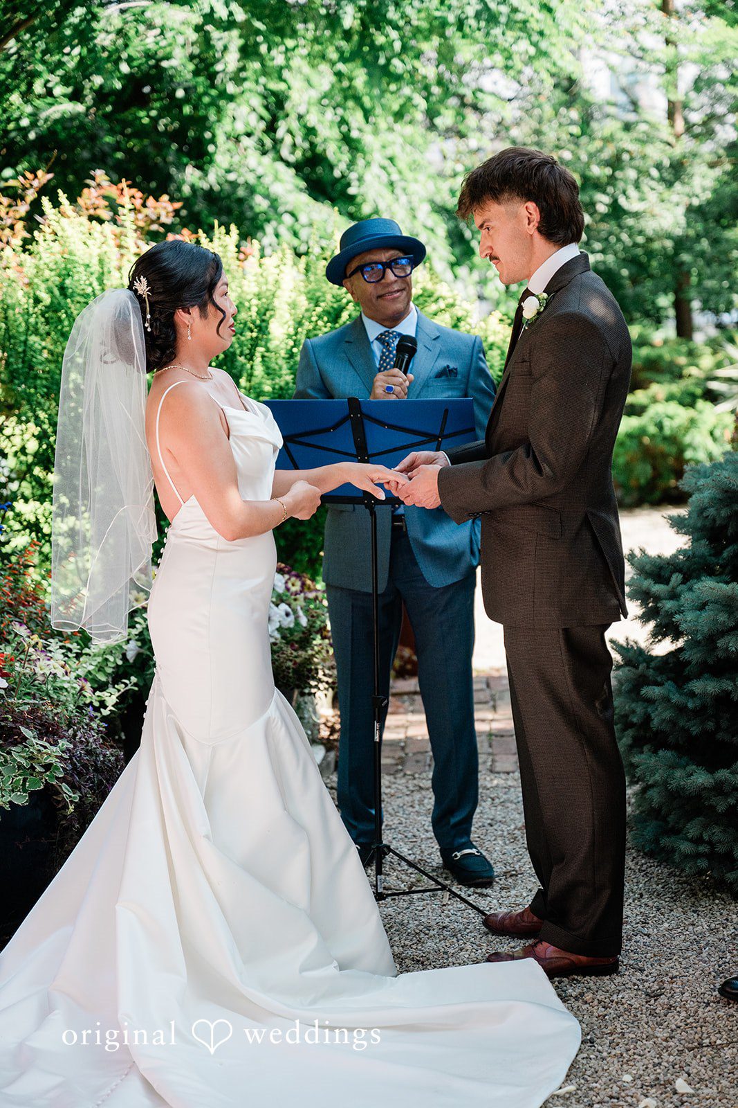 Lauren + Brinton A bride and groom exchanging vows in front of an officiant.