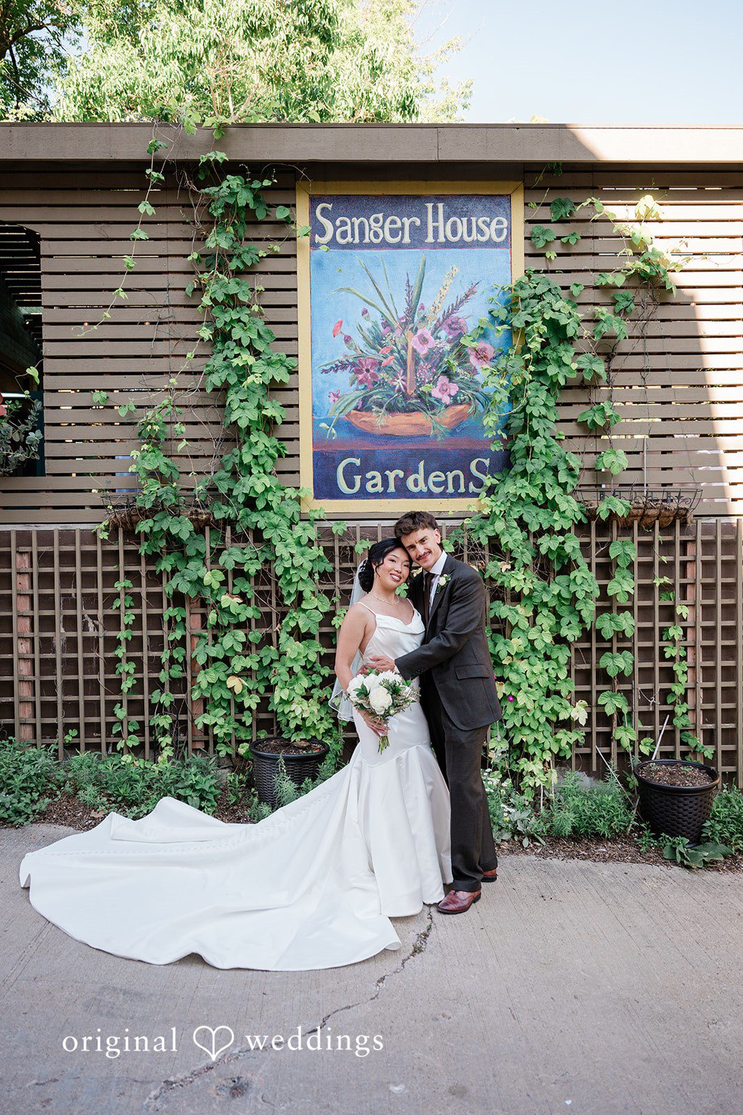 Lauren + Brinton A bride and groom sharing a moment next to a rustic building.