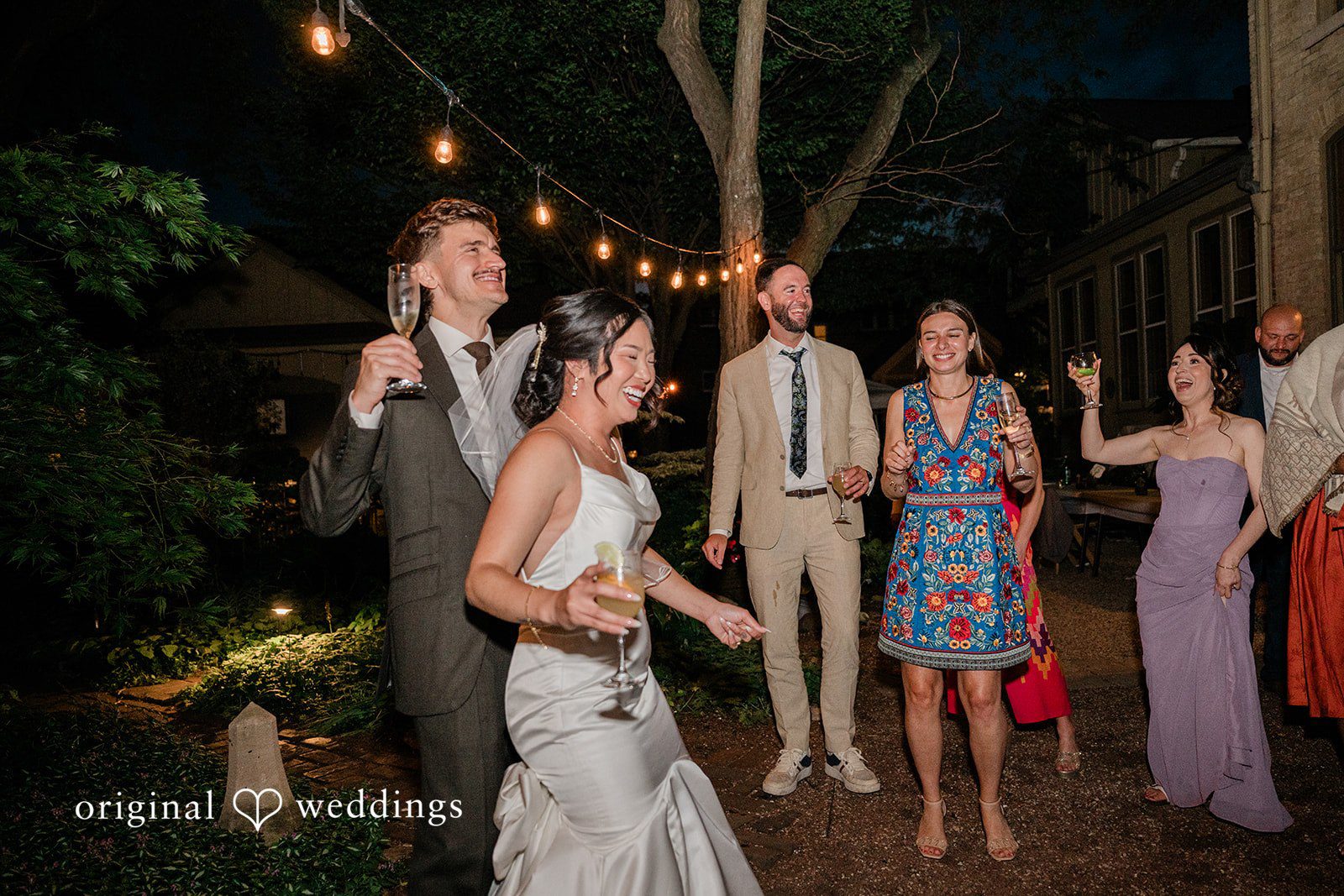 Lauren + Brinton Guests dancing and celebrating on an illuminated dance floor.