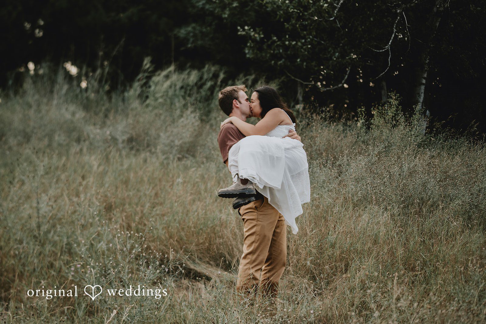 Jake + Ida The groom lifts his bride with a kiss