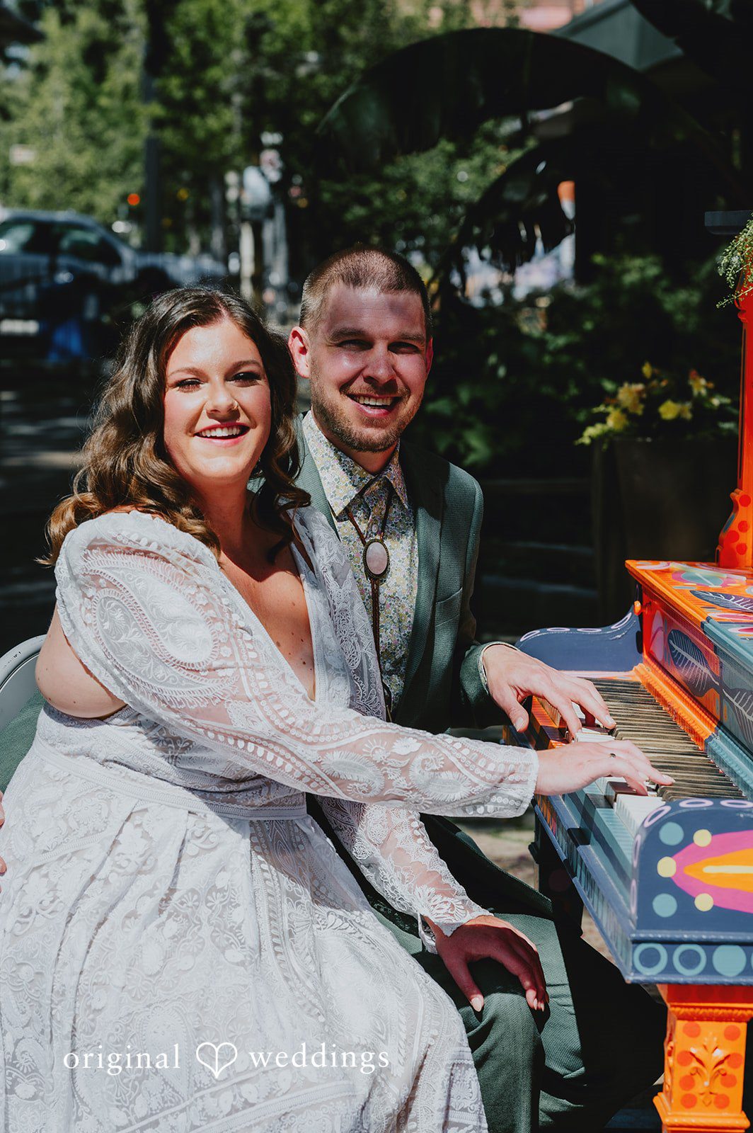 Elizabeth + Willis Couple laughing and sitting together next to a colorful structure.